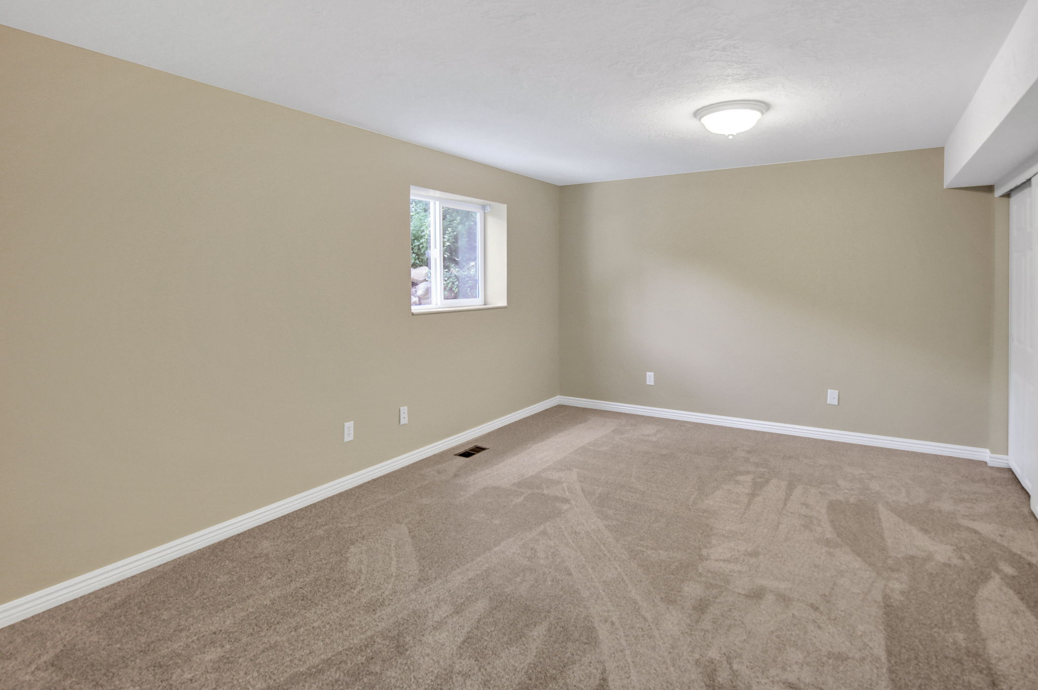 4th bedroom Spacious room featuring neutral carpeting, a single window, and a flush-mount ceiling light fixture