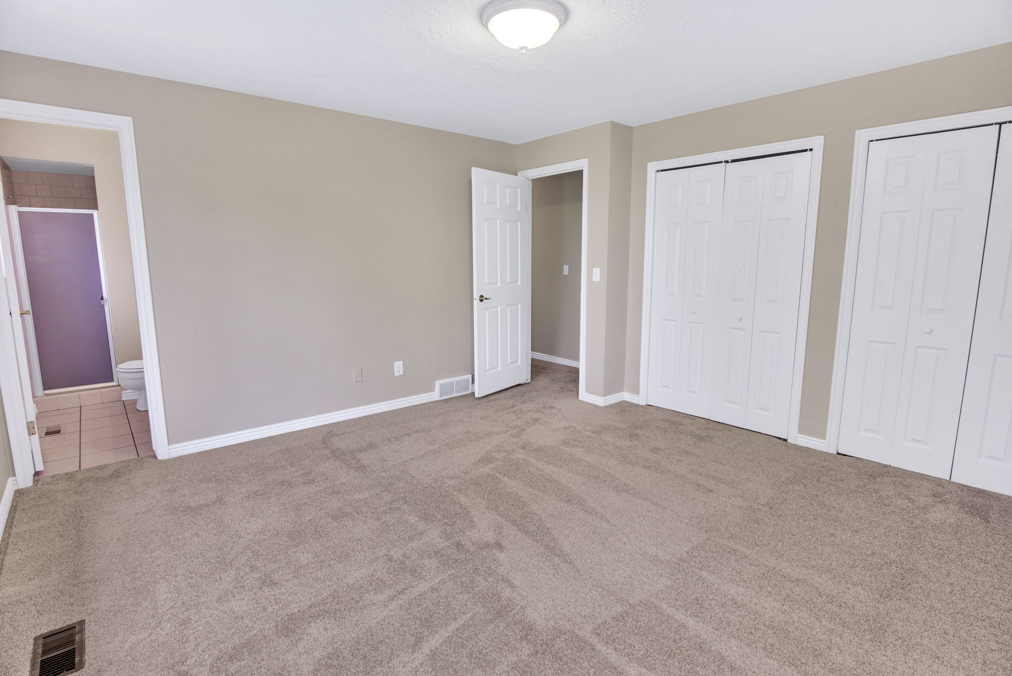 View 2 of Primary Spacious double white bi-fold closets, through to ensuite  3/4 bath