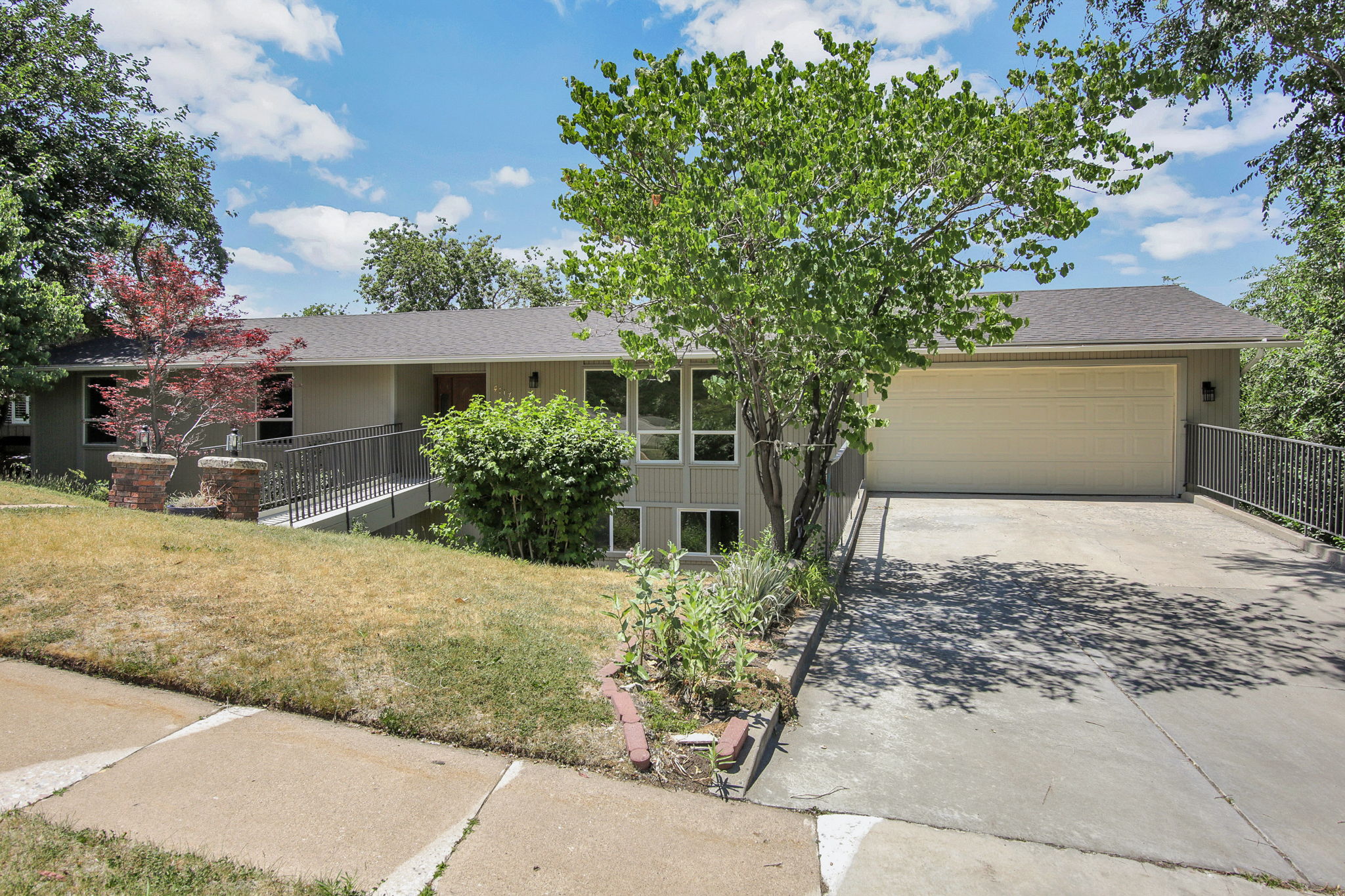 Hillside allows for 2 basement levels, and mature landscaping. Deeper garage