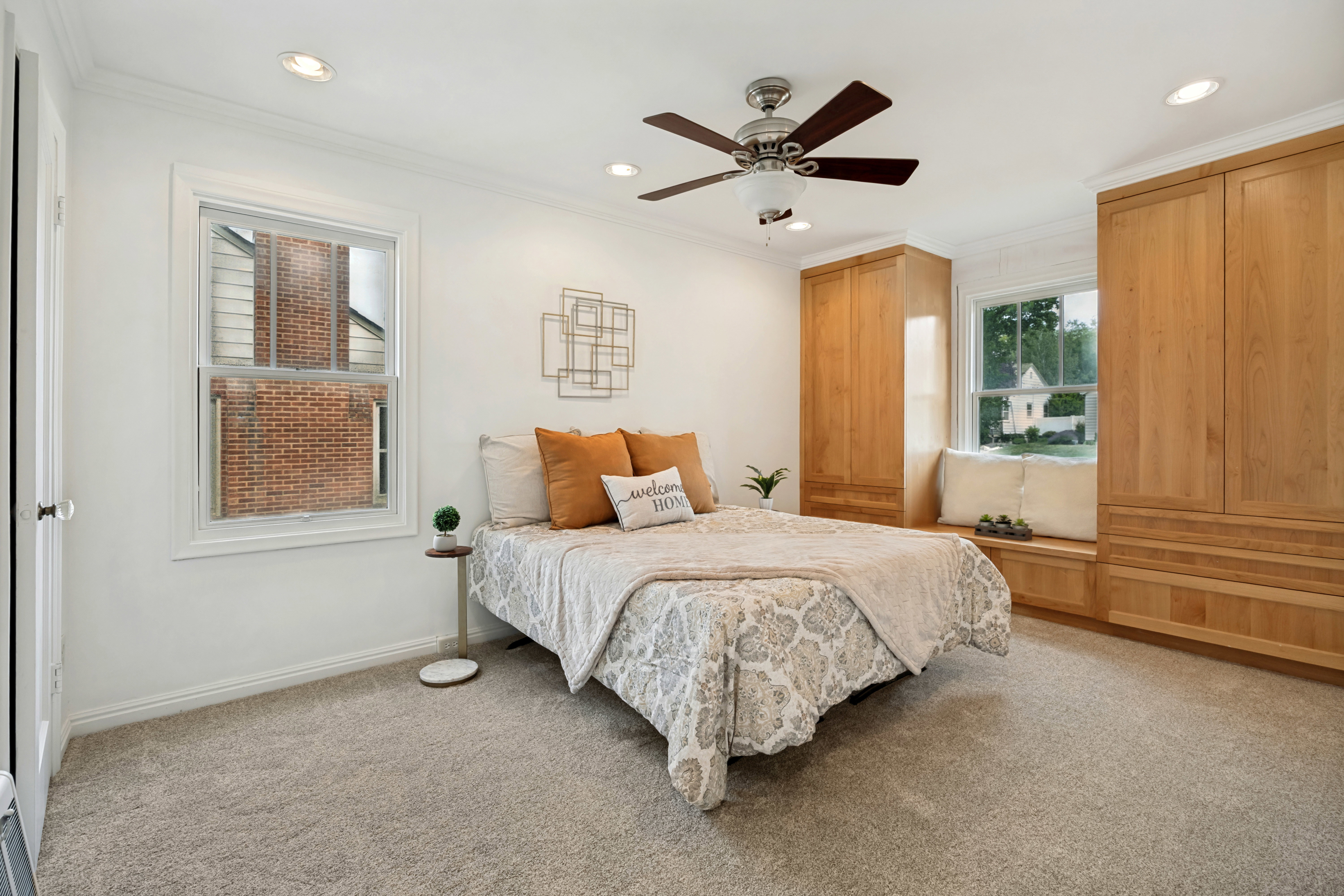 Carpeted room featuring recessed lighting, a ceiling fan, a built-in window seat, and integrated wood-finish cabinetry
