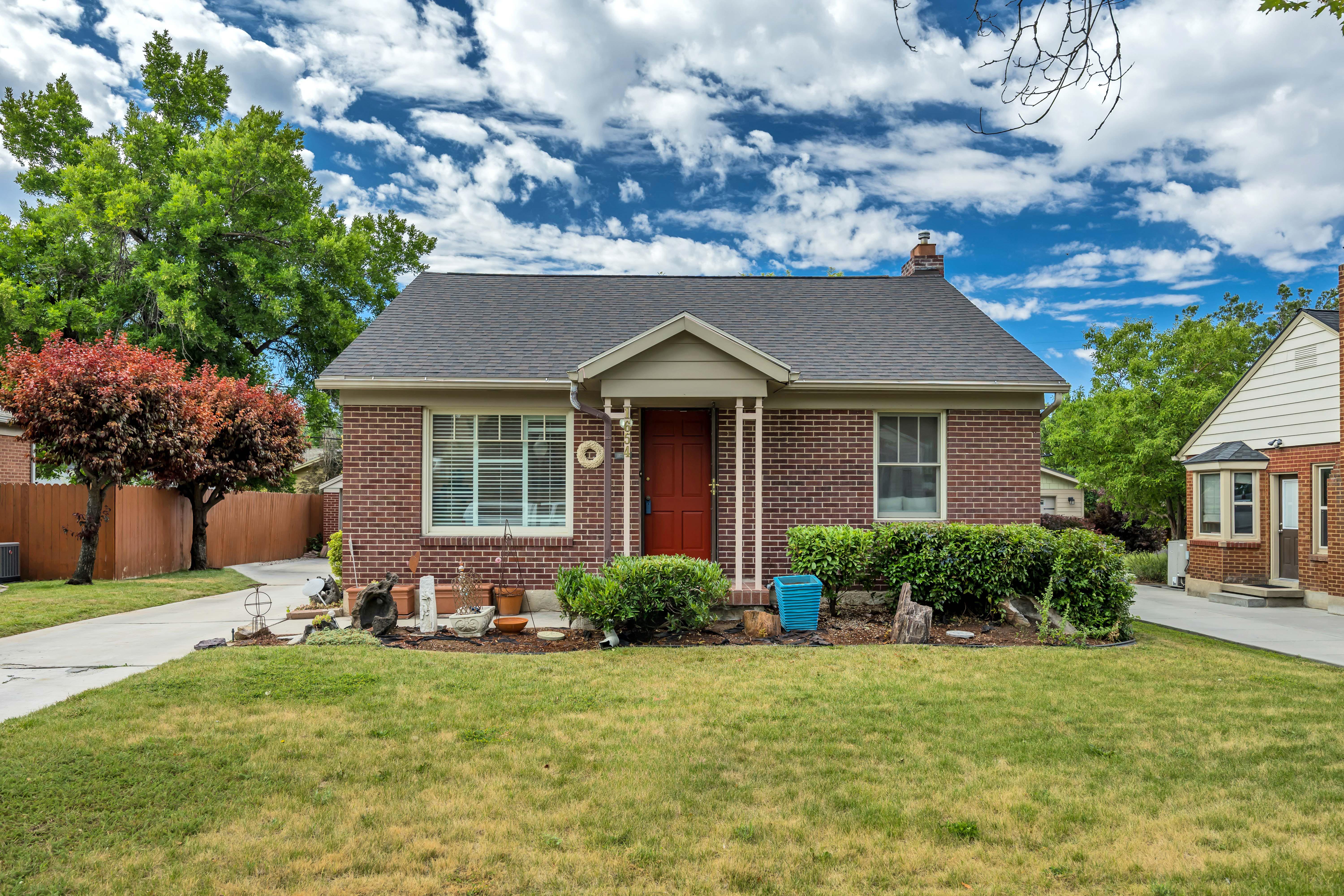 Brick exterior residence featuring a gabled roofline
