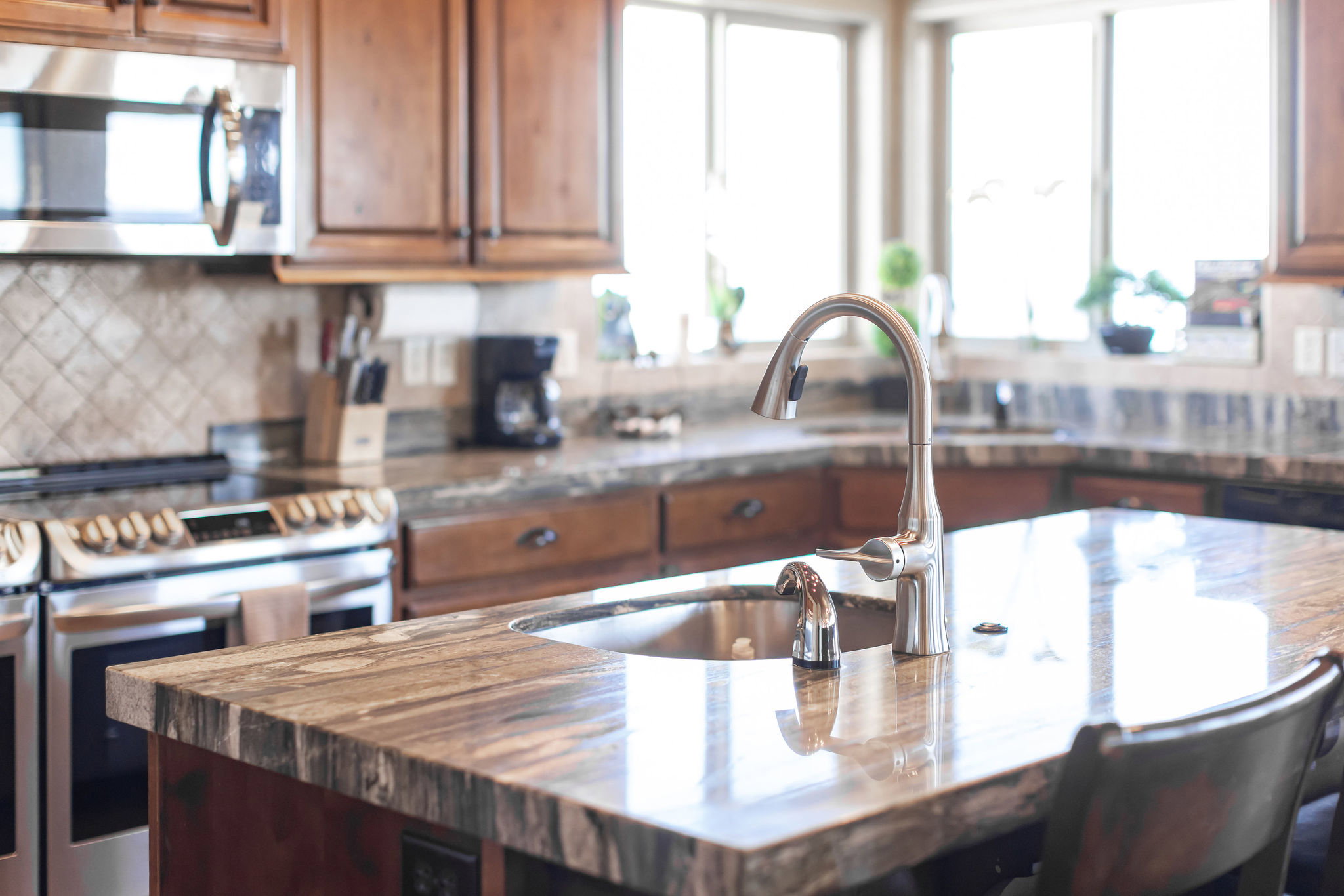 Kitchen island with an undermount sink and gooseneck faucet