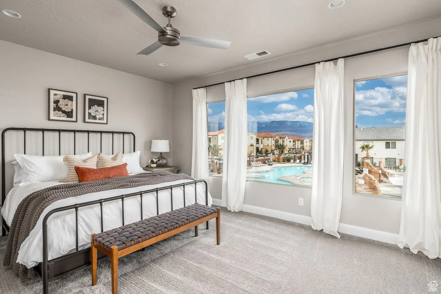Spacious bedroom featuring large windows, a ceiling fan, recessed lighting, and soft gray carpeting