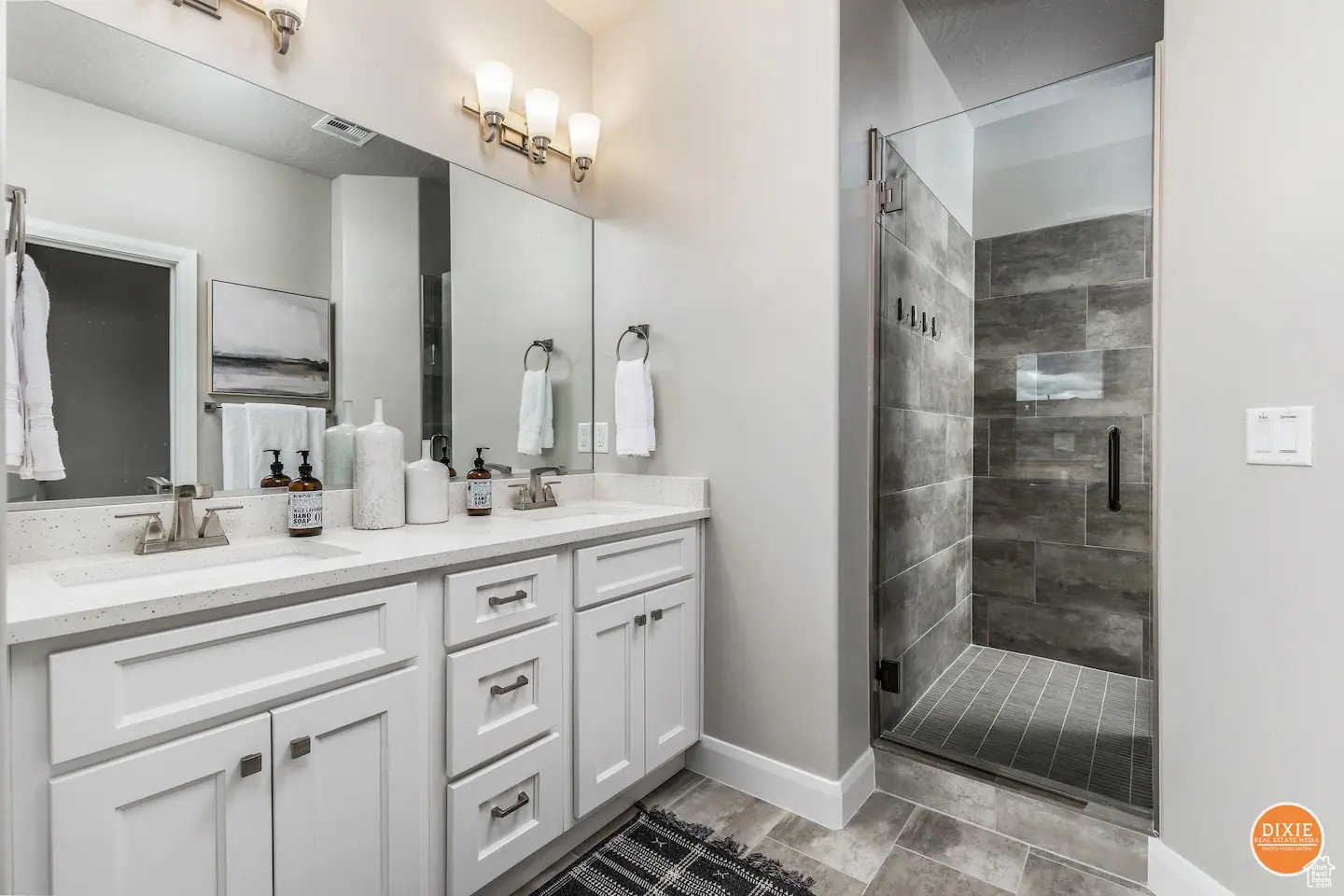 Double vanity with white cabinetry, light-toned countertops, and brushed nickel fixtures