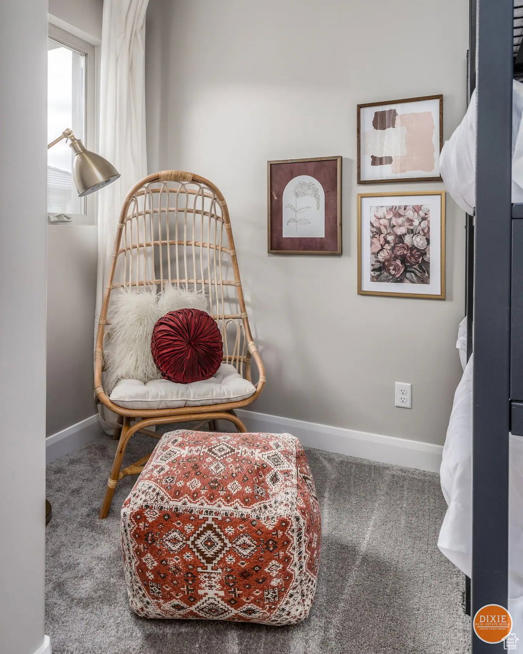 Plush gray carpeting extends throughout this corner space, complemented by light-toned wall paint and white trim