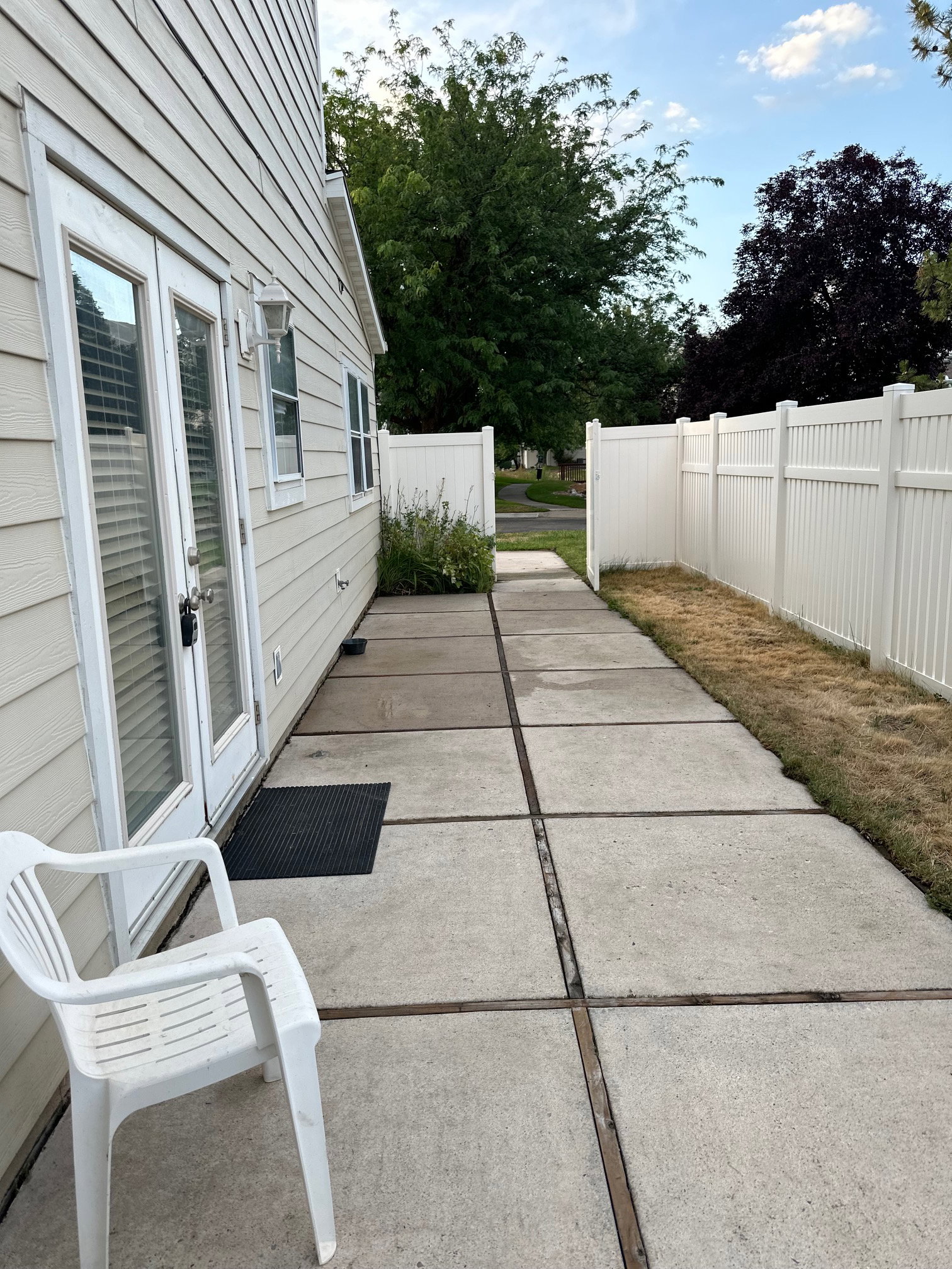 Private concrete patio accessed via double glass-paned doors.