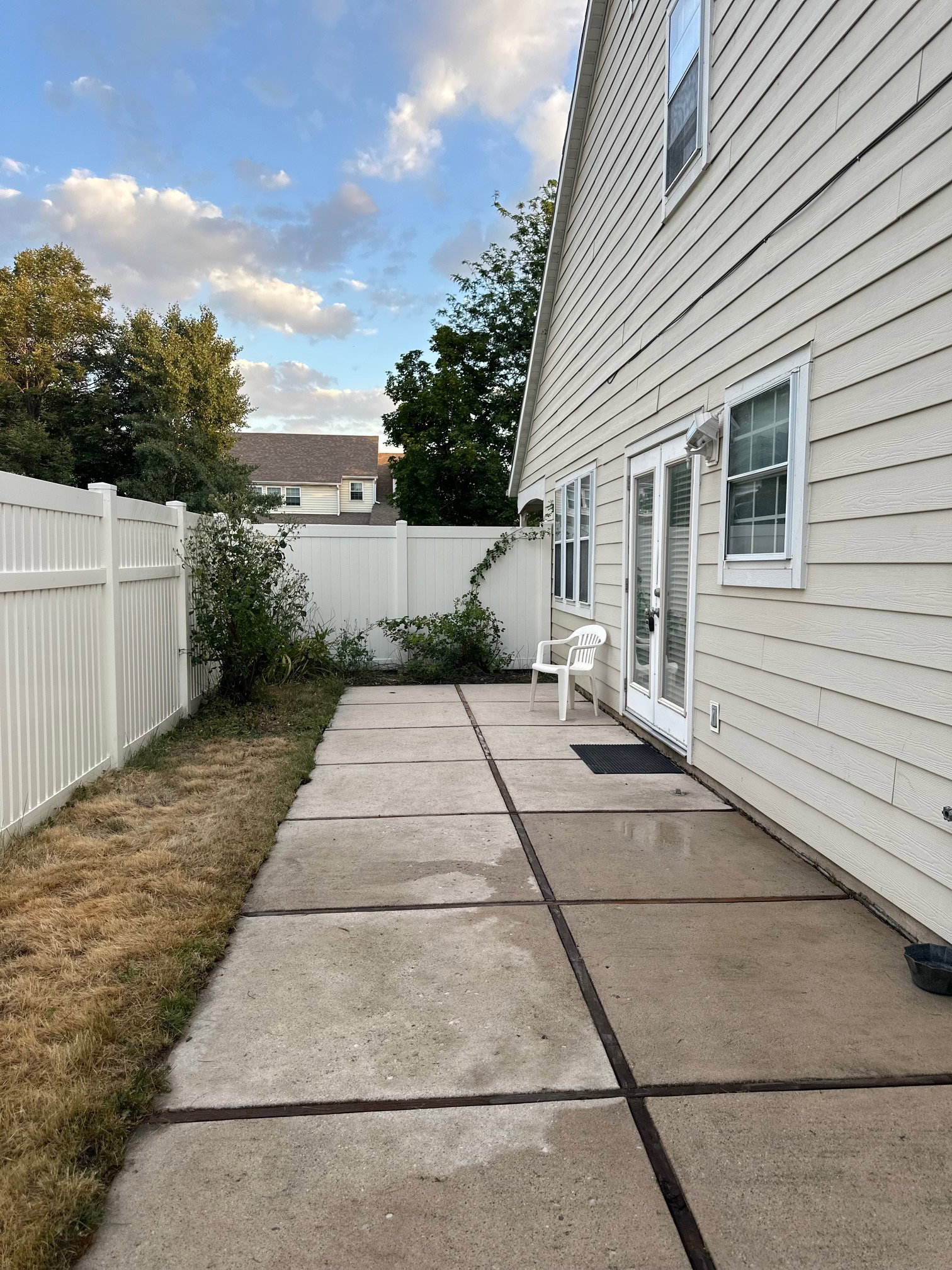 Nice concrete patio offering direct outdoor access through double French doors