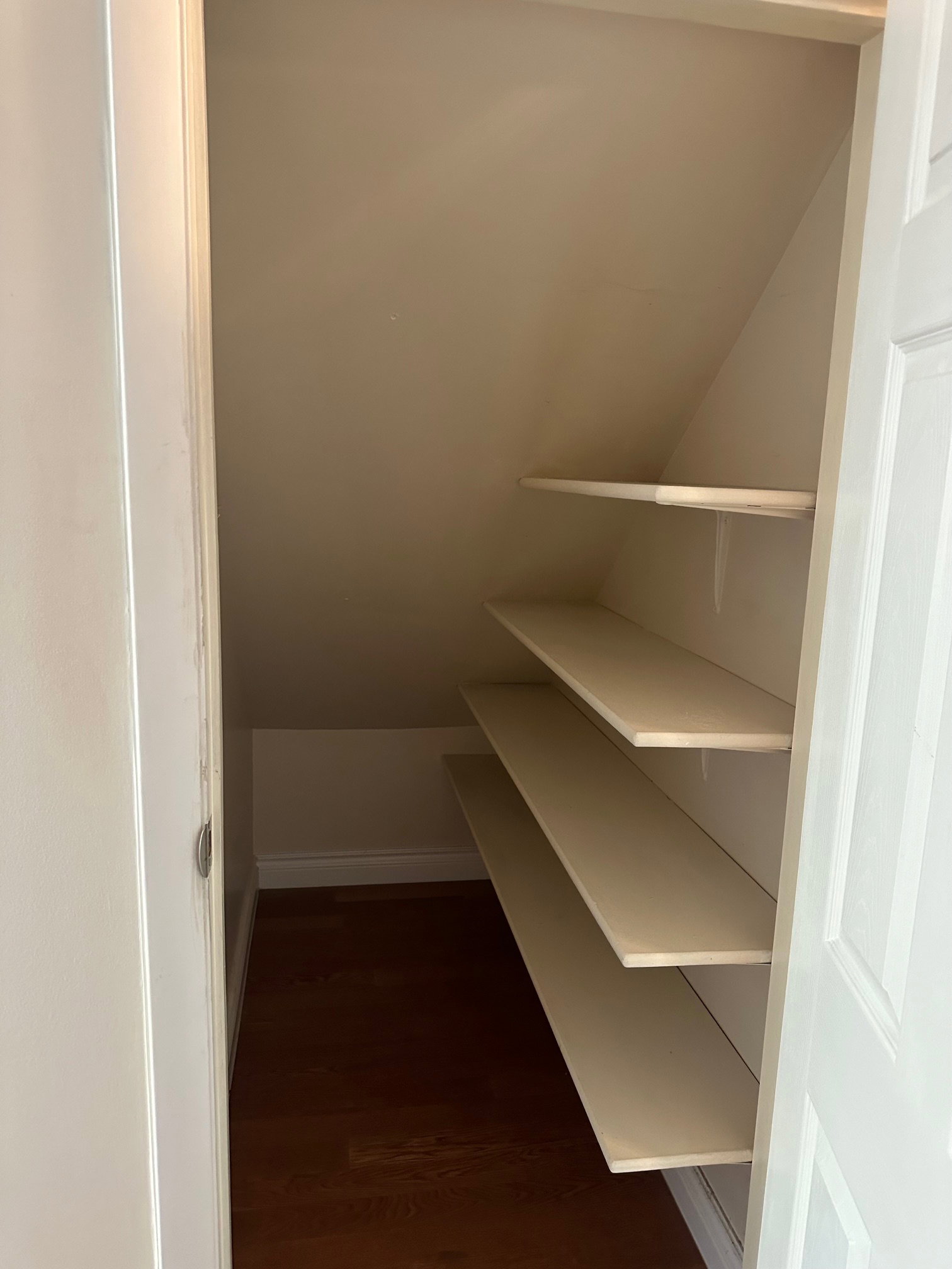 Built-in shelving within a sloped Pantry storage area