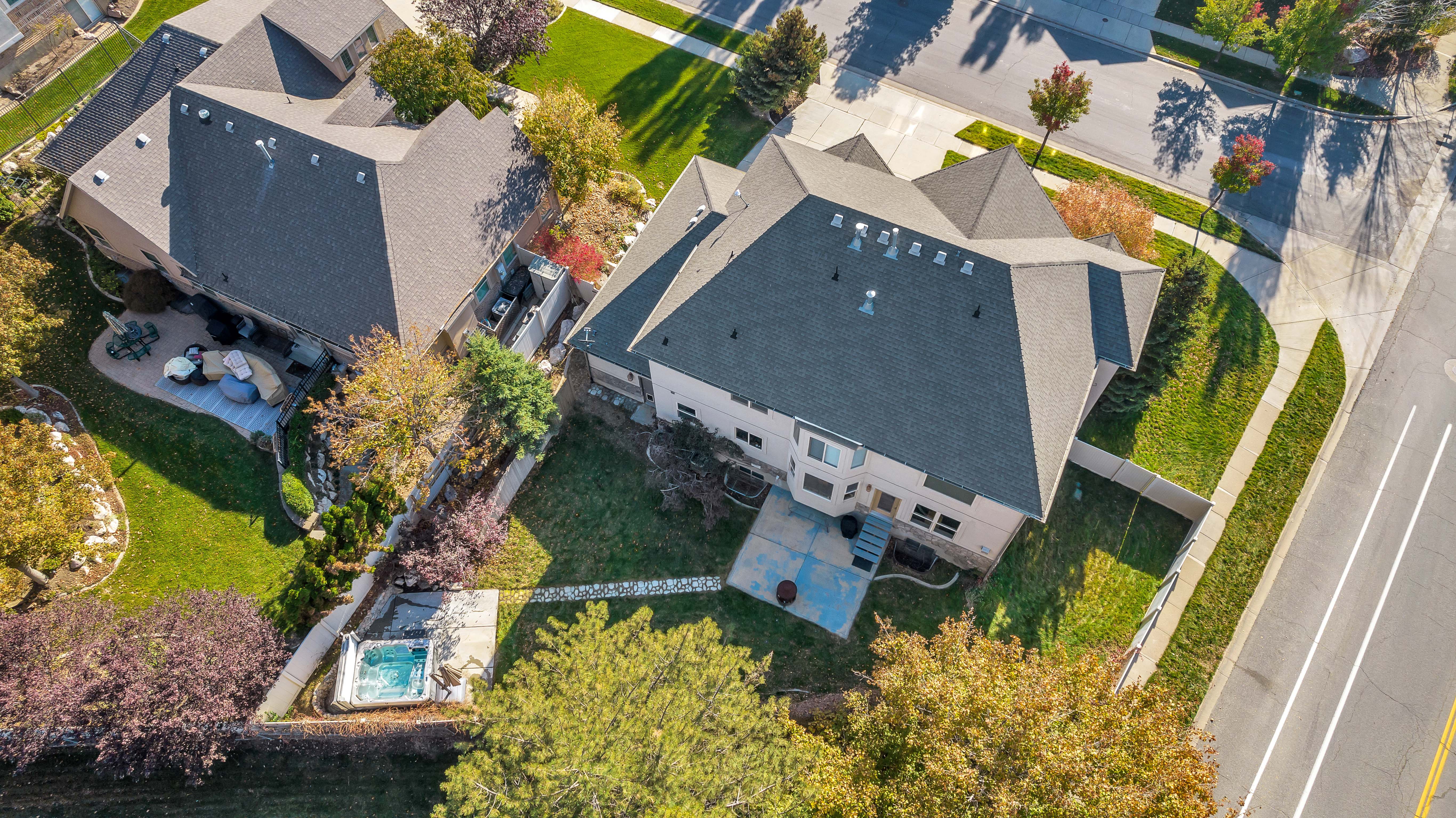 Aerial perspective showcasing a property with a multi-gabled roofline and extensive landscaping