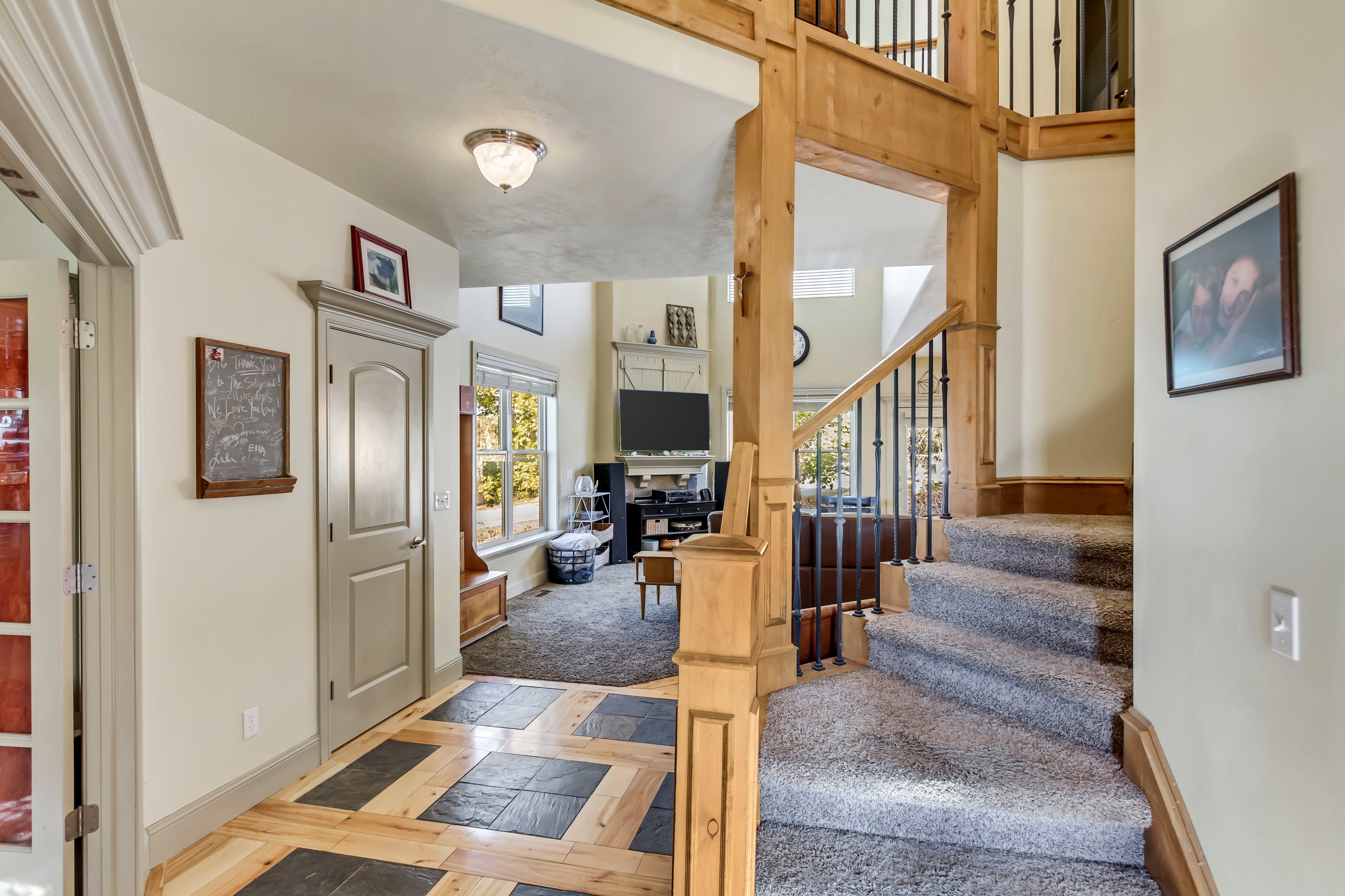 Inviting entryway featuring a wood-finish and slate tile floor
