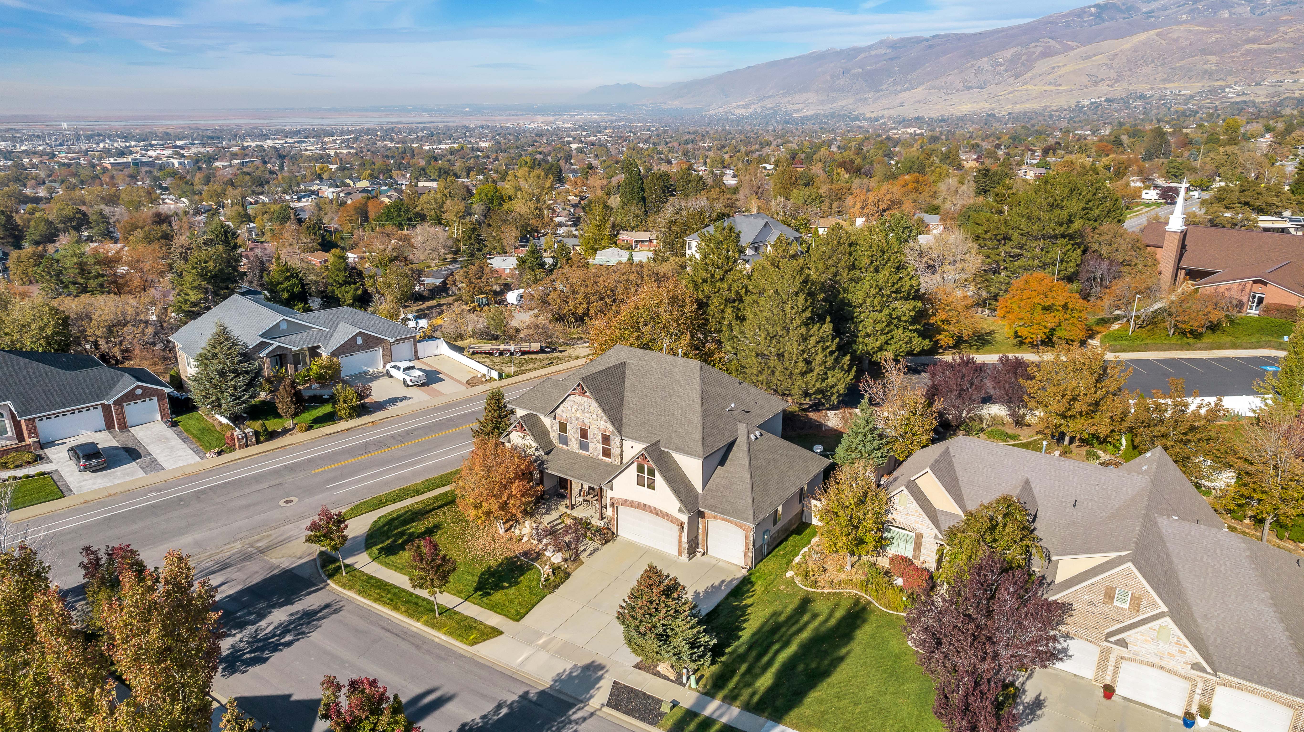 Expansive aerial perspective showcasing a residential neighborhood with a distant mountain range backdrop