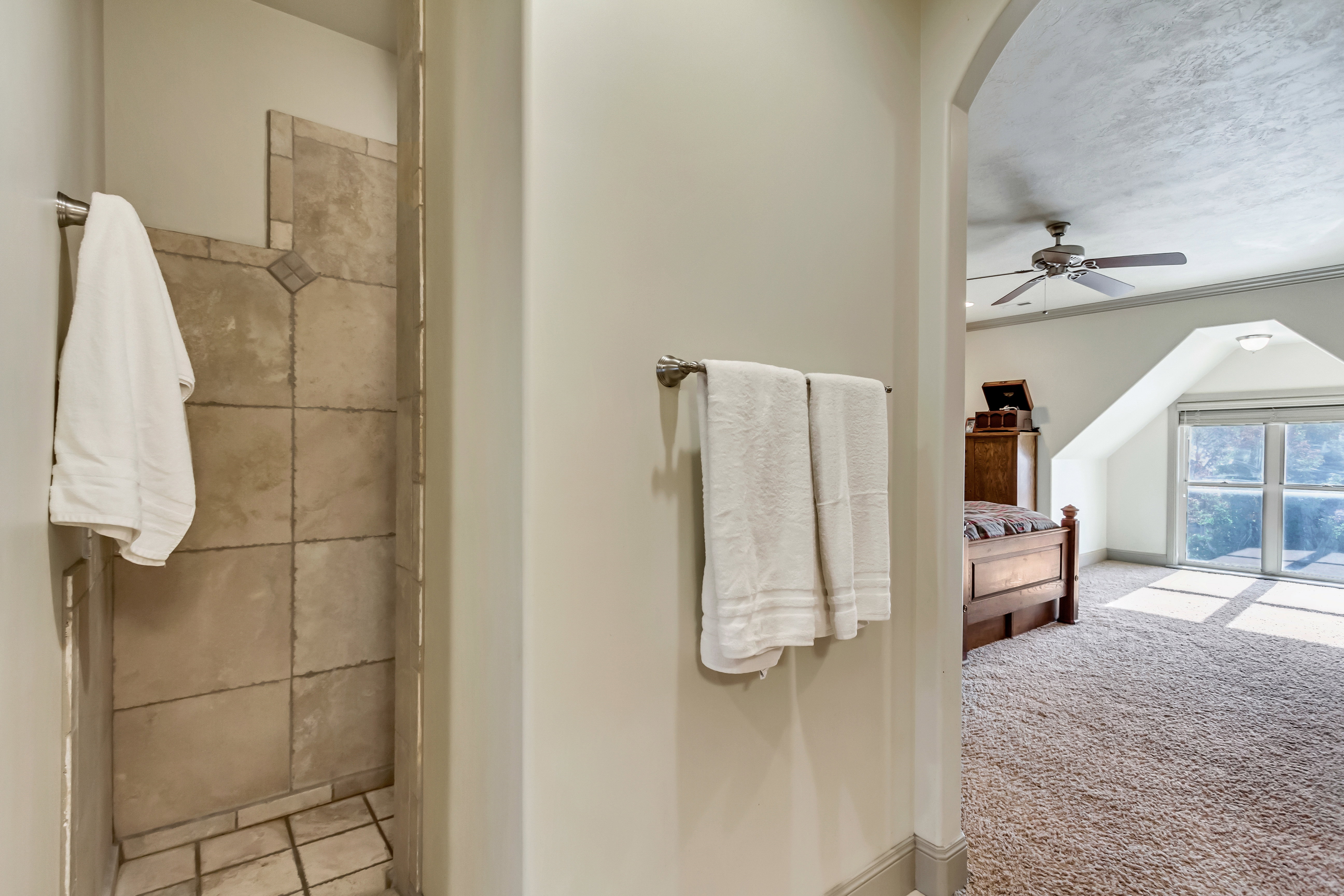 Tiled shower stall with a neutral palette