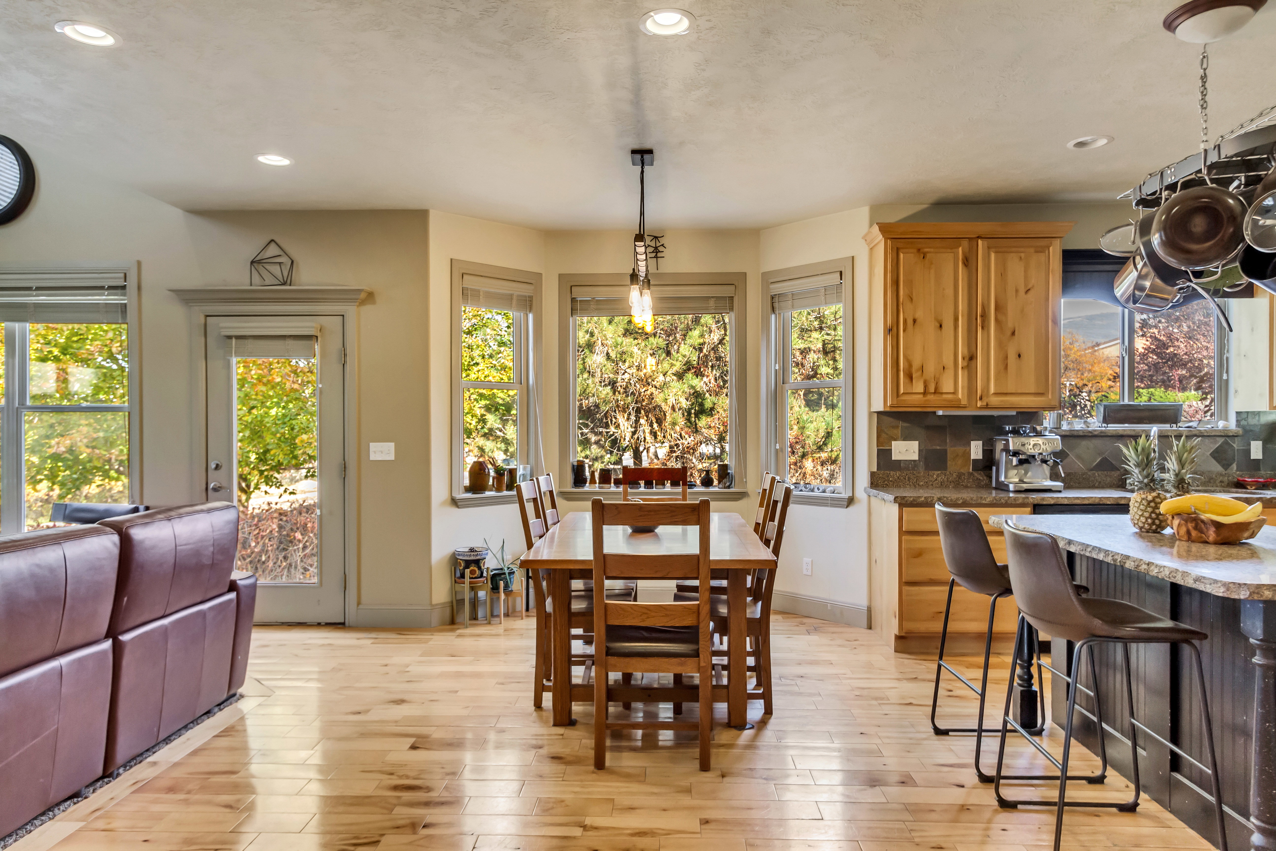 Open-concept living space with light wood-finish flooring