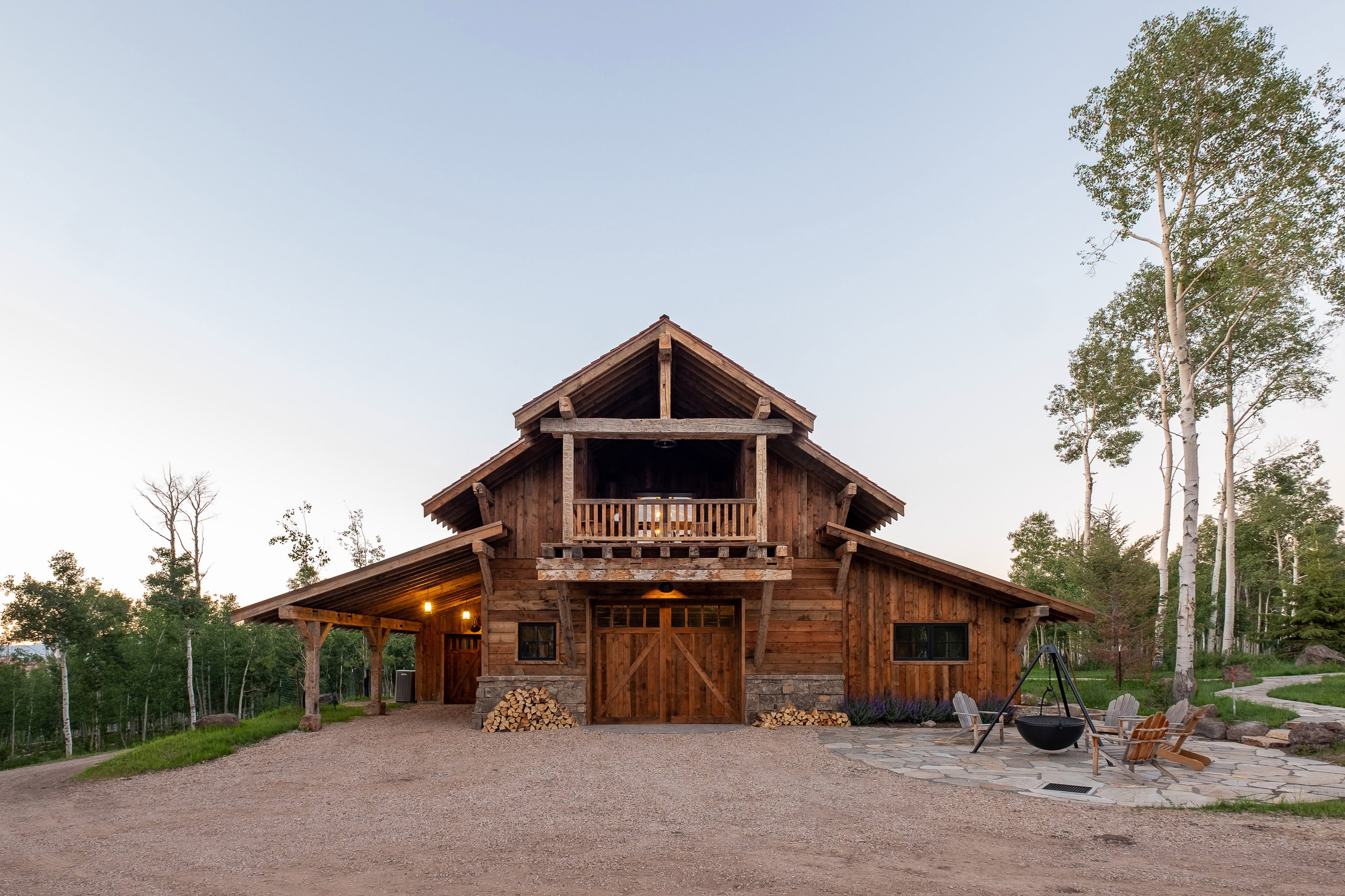 Rustic timber frame exterior with a second-story balcony