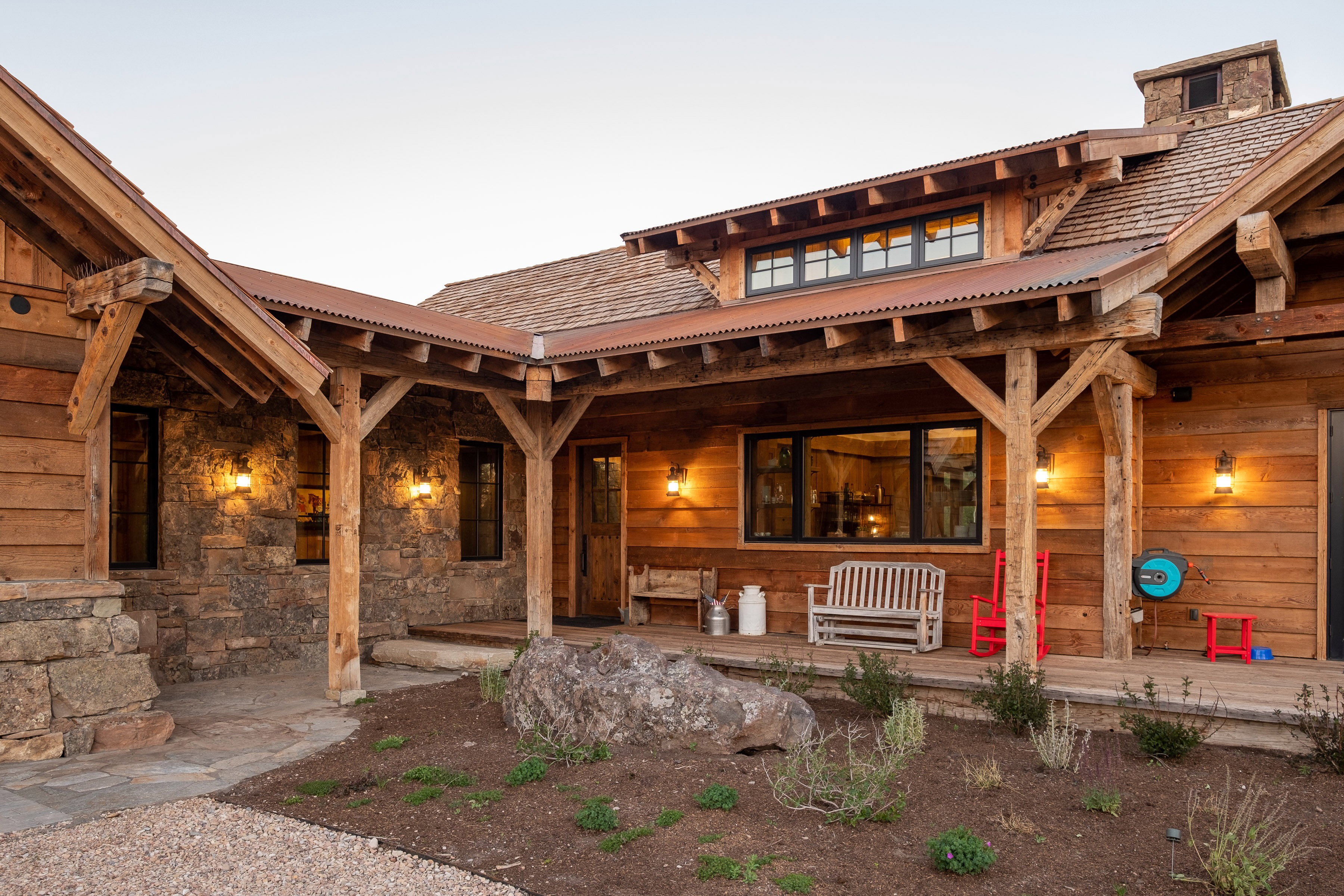 Rustic-inspired exterior featuring natural wood siding and stone veneer