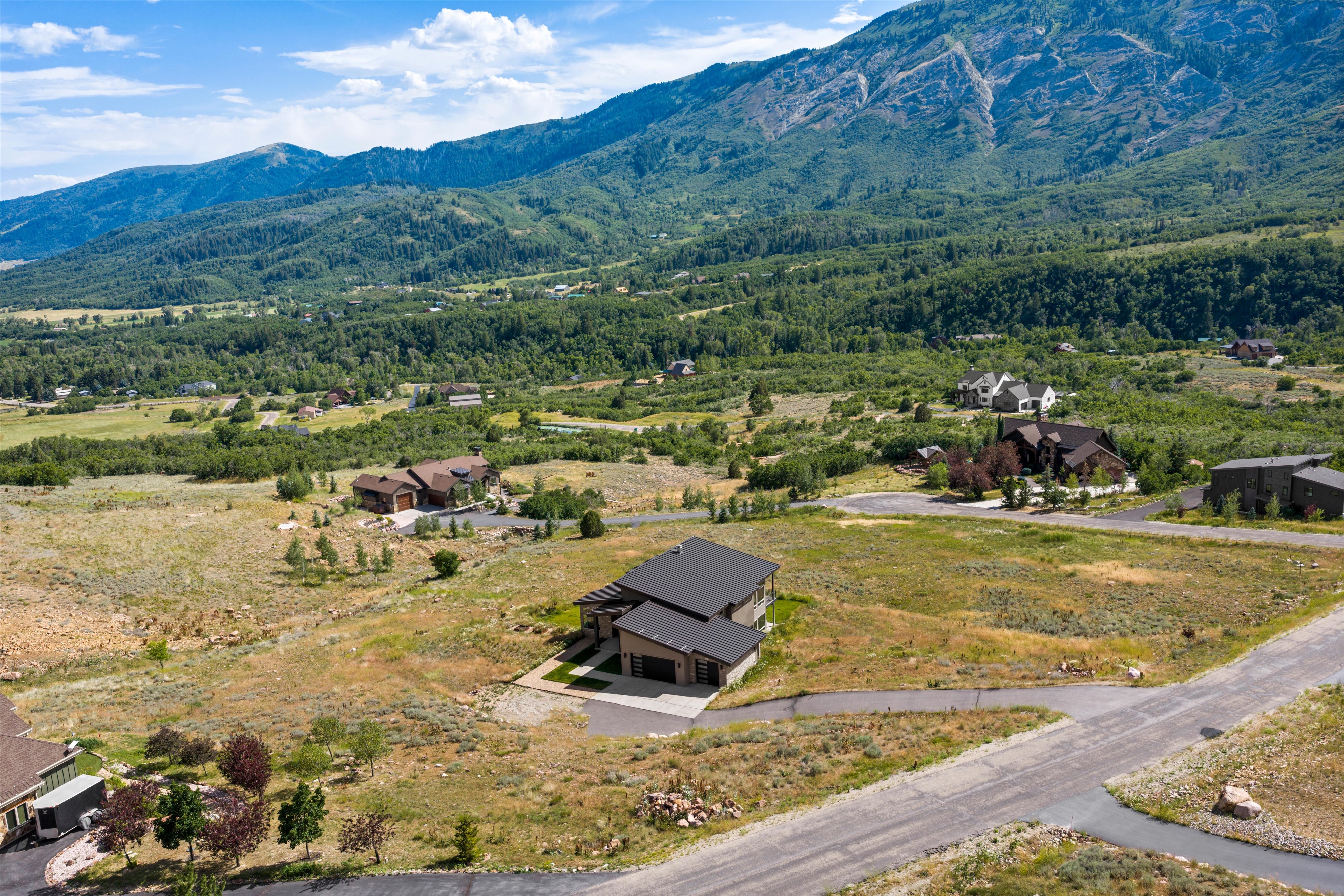 Contemporary mountain residence featuring a multi-level design and an attached three-car garage