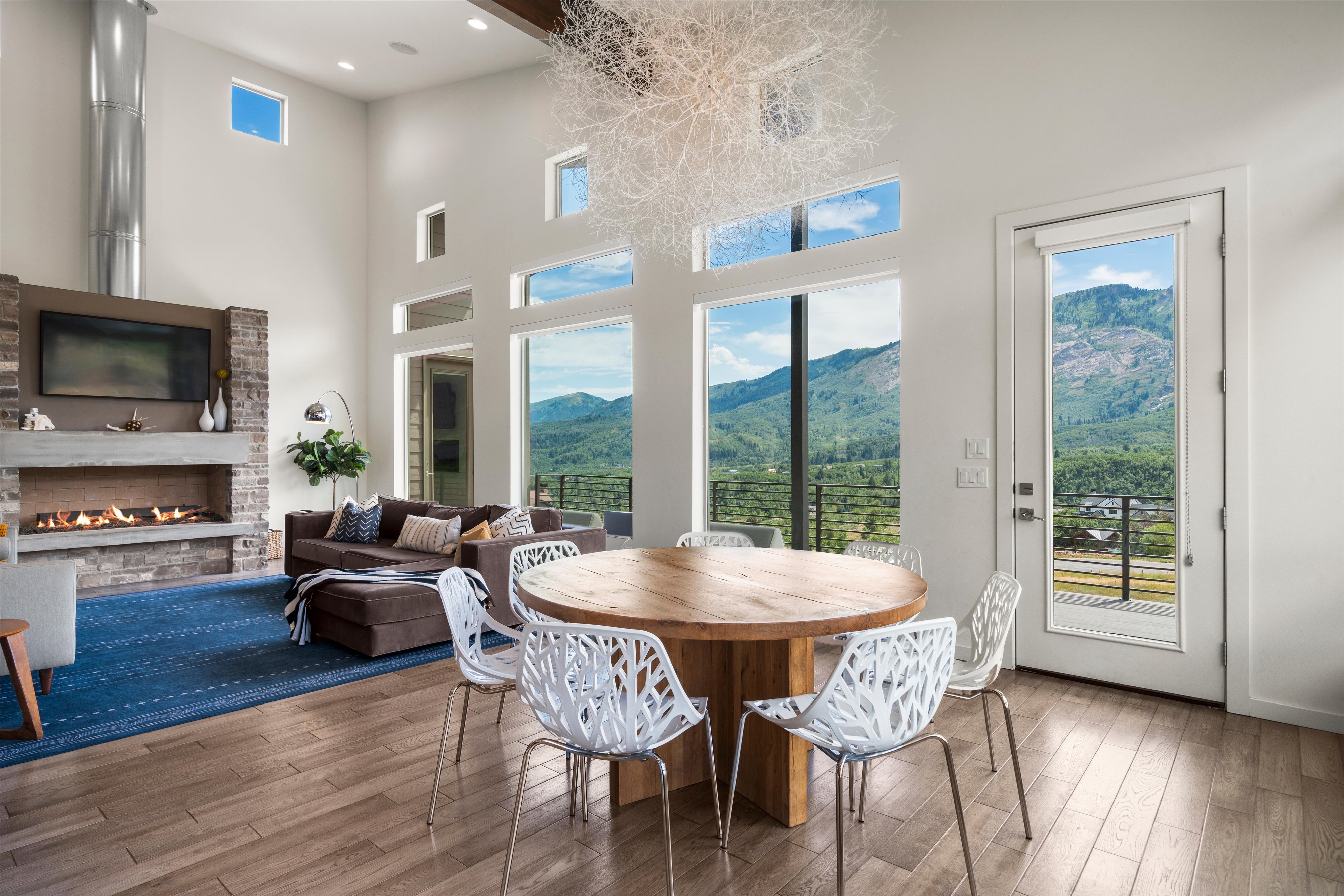 Spacious living area featuring high ceilings and extensive window walls