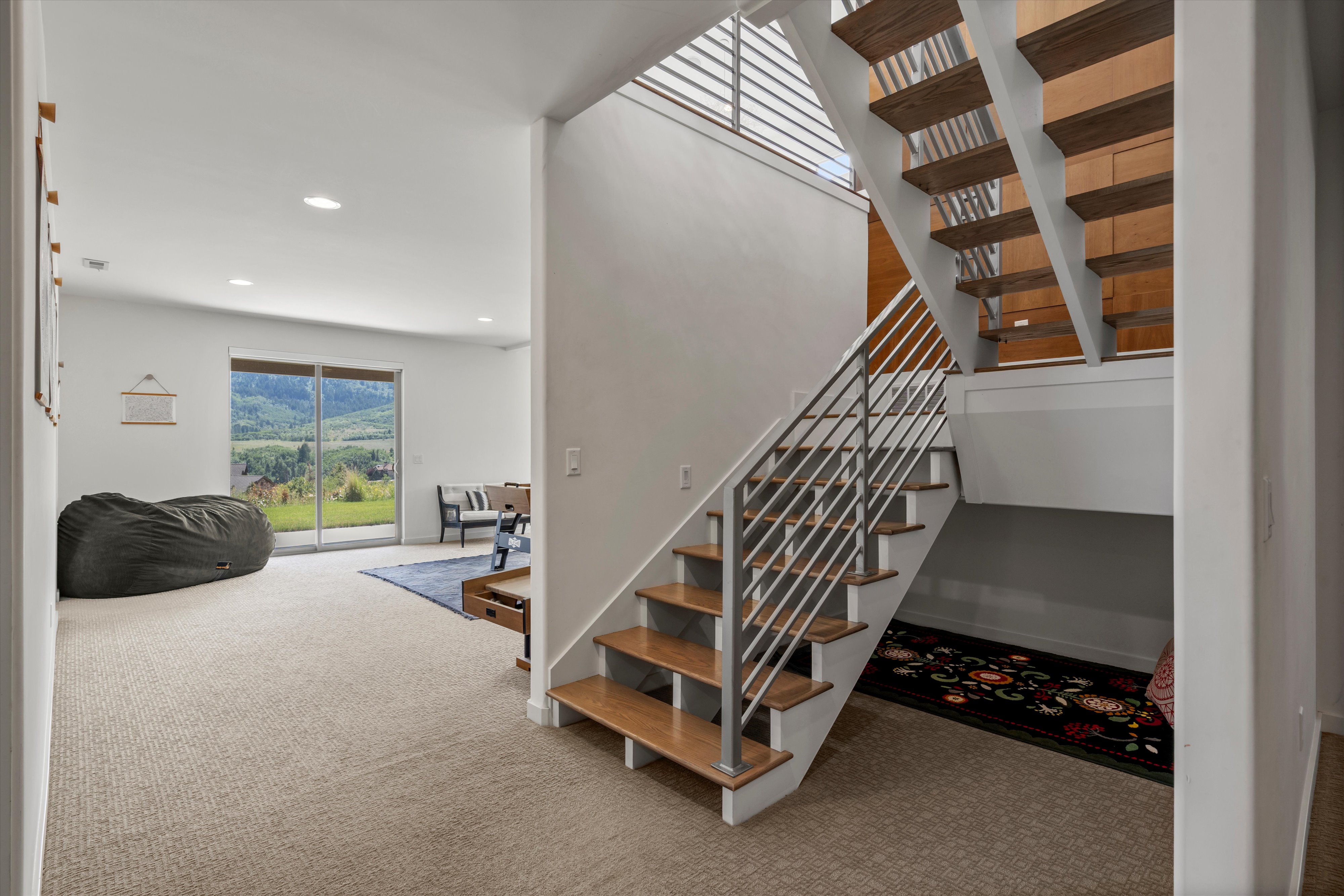Open-riser staircase with wood-finish treads and metal railing