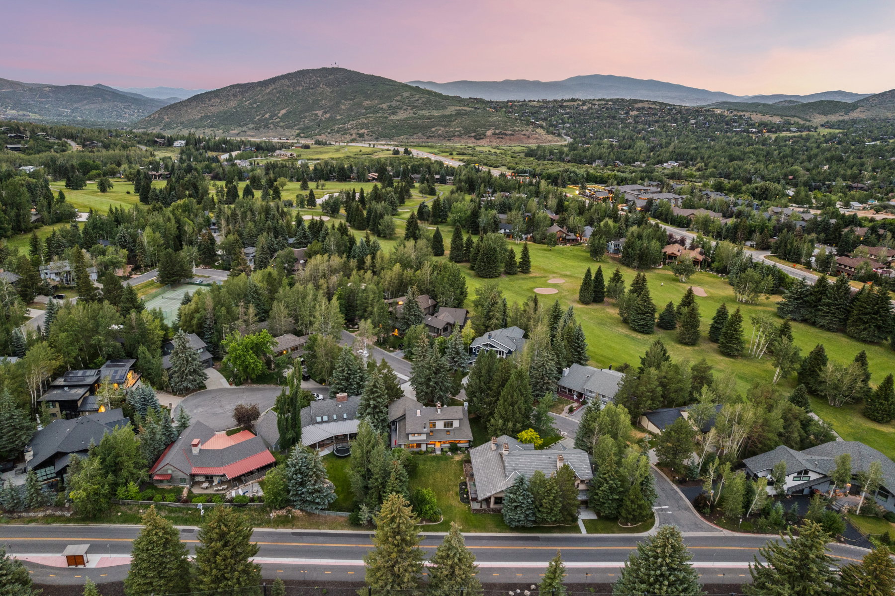 Expansive residential area featuring numerous properties surrounded by mature trees