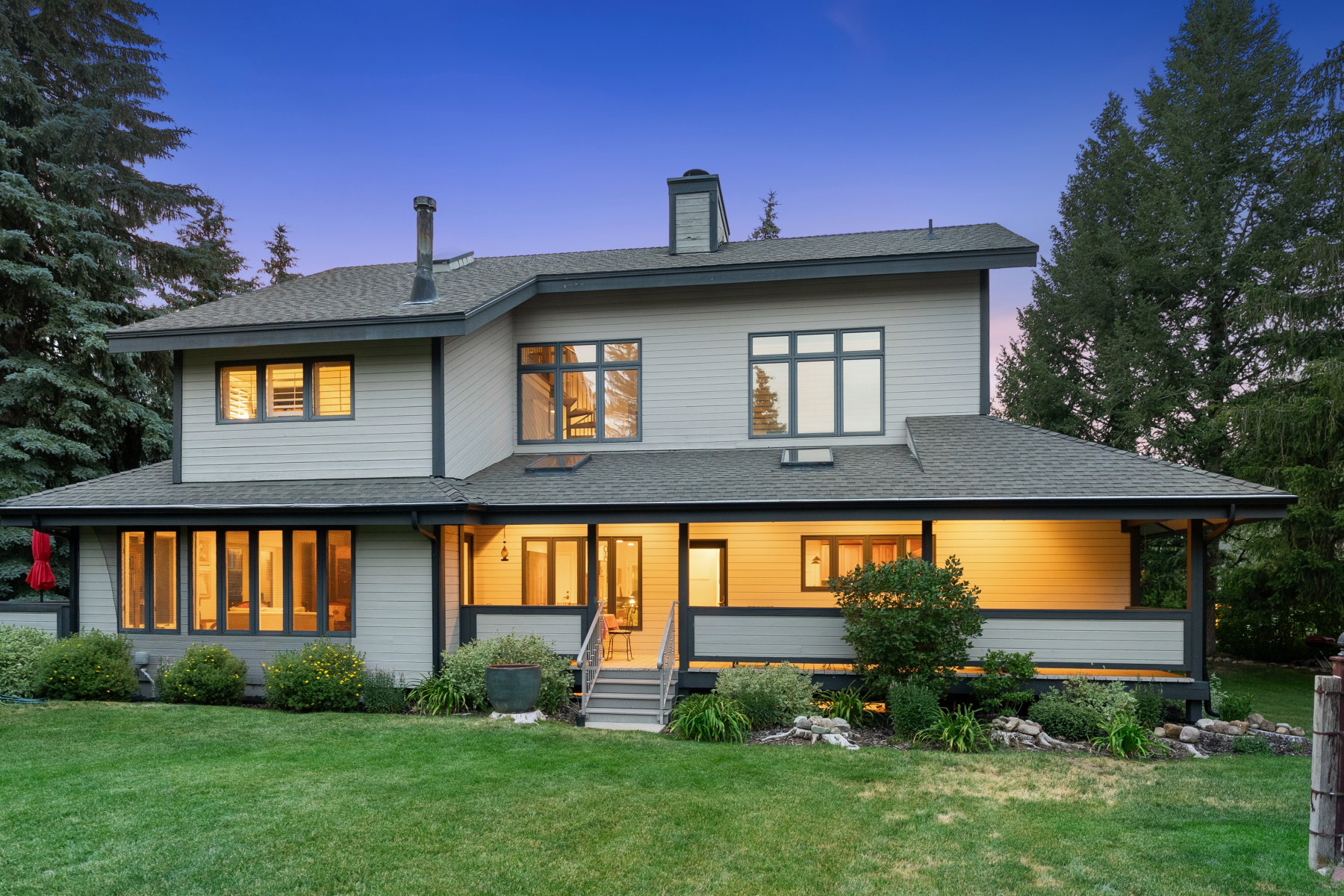 Contemporary two-story residence with a covered porch and deck