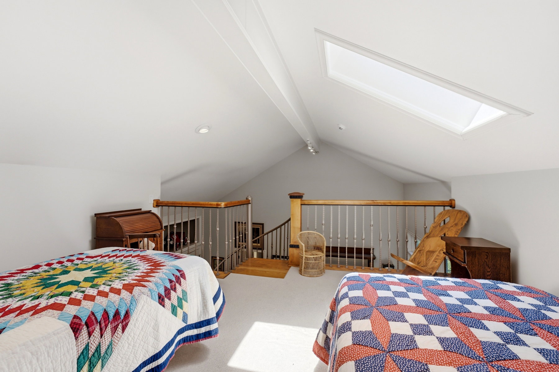 Loft space featuring a vaulted ceiling and skylight
