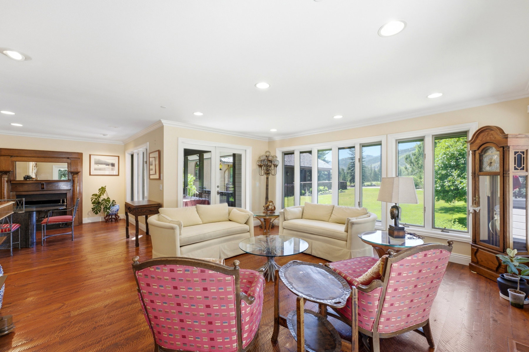 Hardwood flooring throughout featuring a corner fireplace with an ornate wood mantle