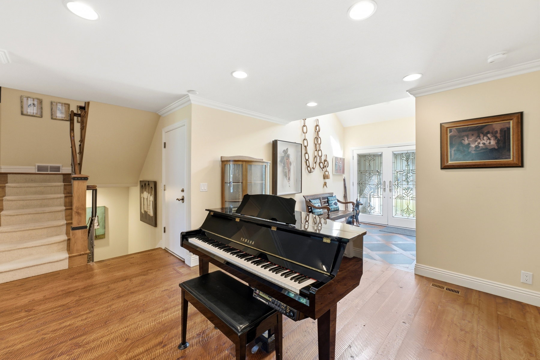 Entry foyer featuring light wood-finish flooring, recessed ceiling lighting, and crown molding