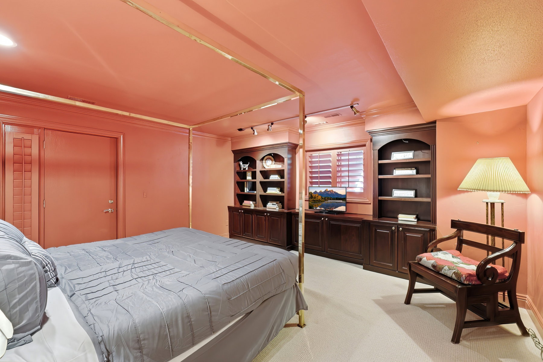 Integrated dark wood built-in shelving and cabinetry with a central media console