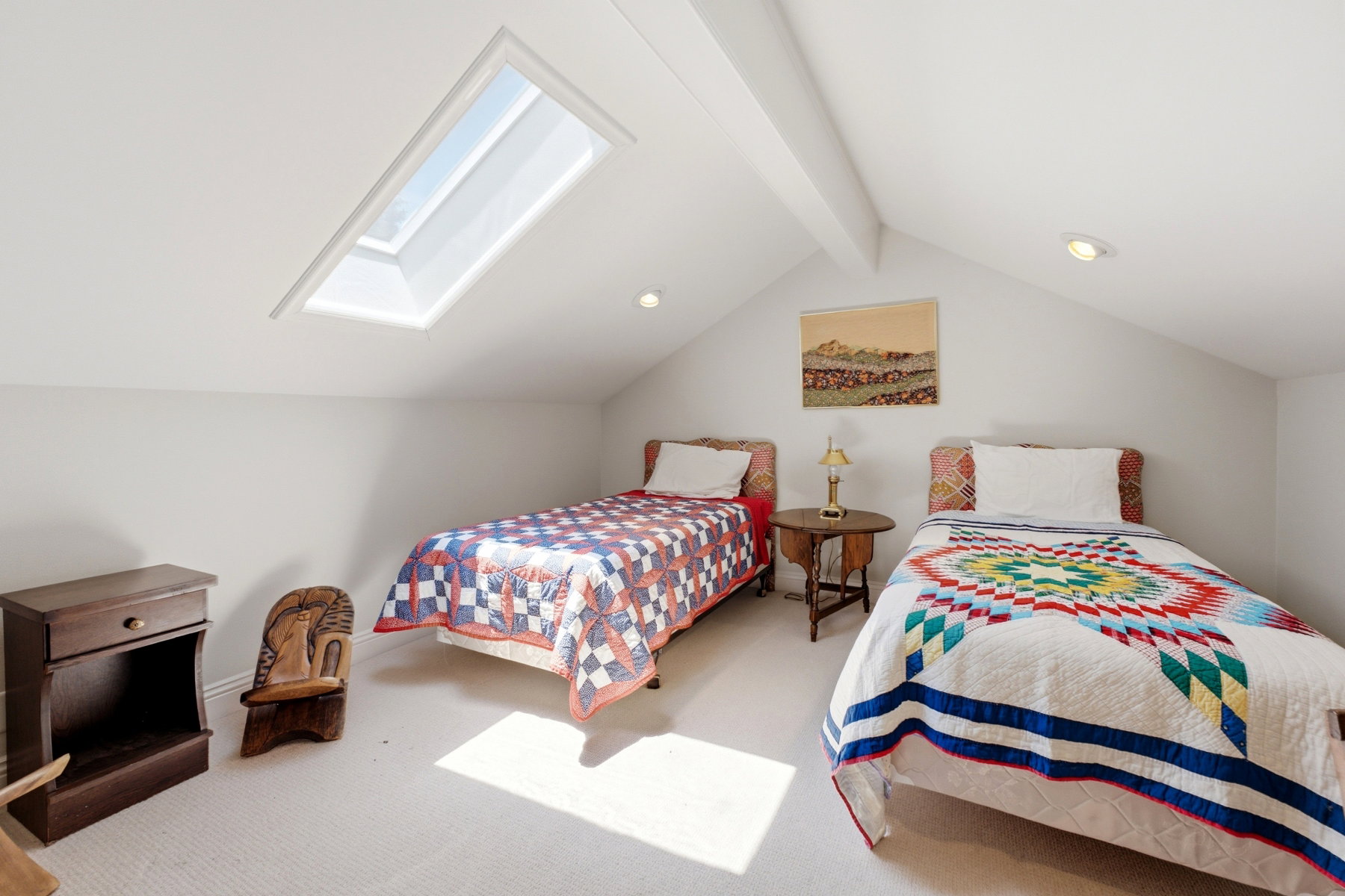 Attic bedroom featuring a prominent skylight, sloped ceilings, recessed lighting, white wall paint, and light-toned carpeting