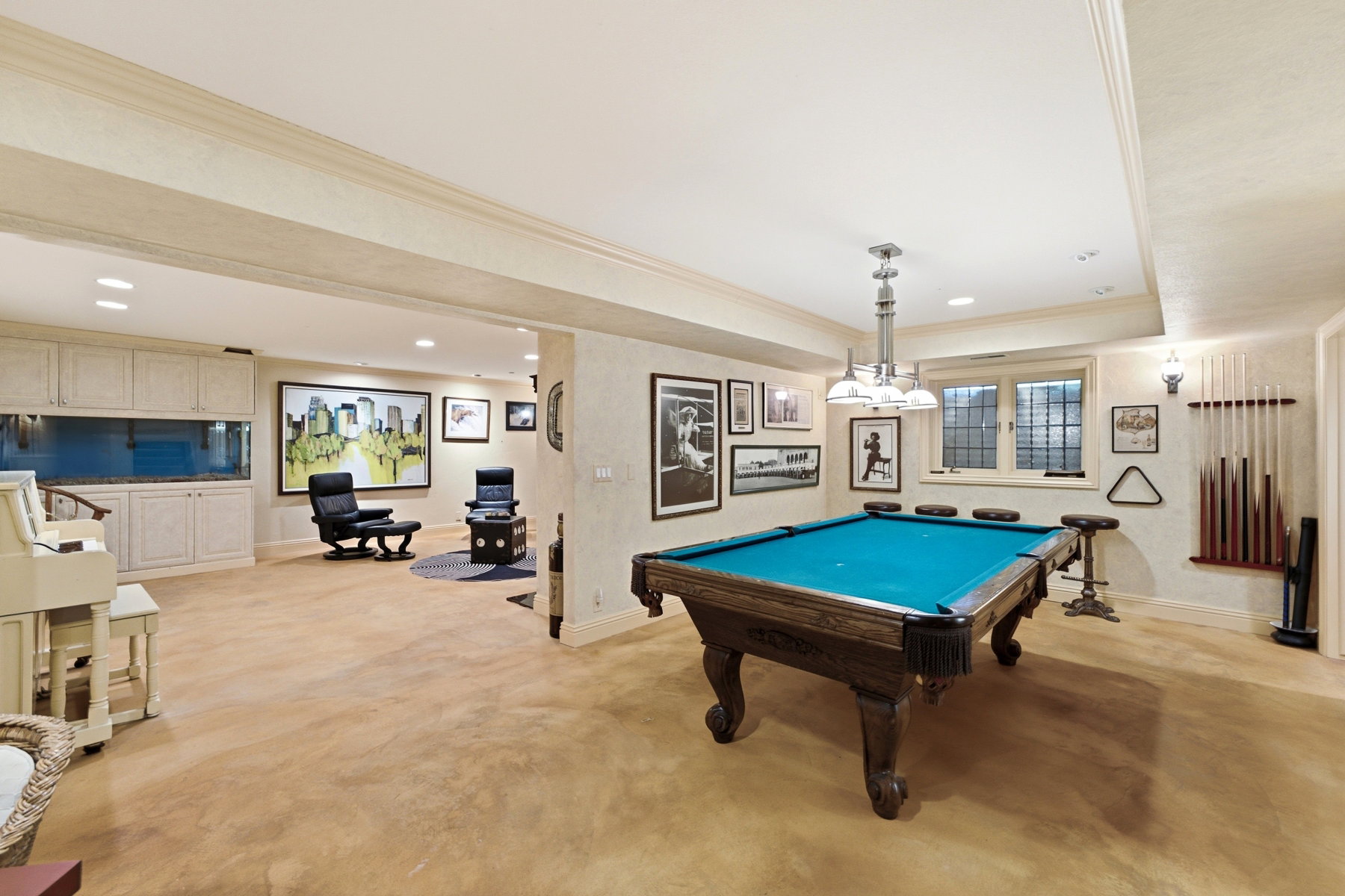 Recreational area featuring a billiards table with a teal felt surface and carved wooden legs, recessed lighting, and a window with security bars