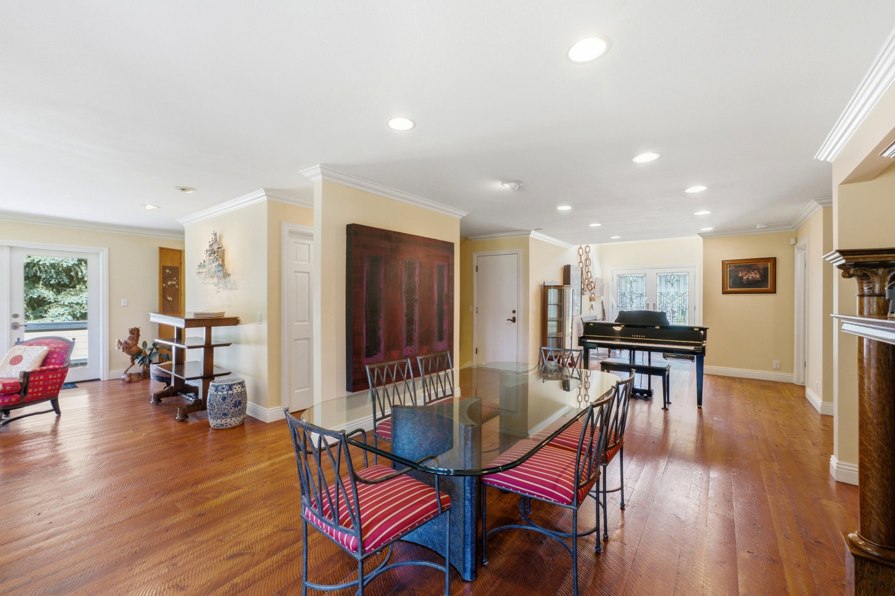 Expansive room featuring wood-finish flooring, recessed lighting, and crown molding