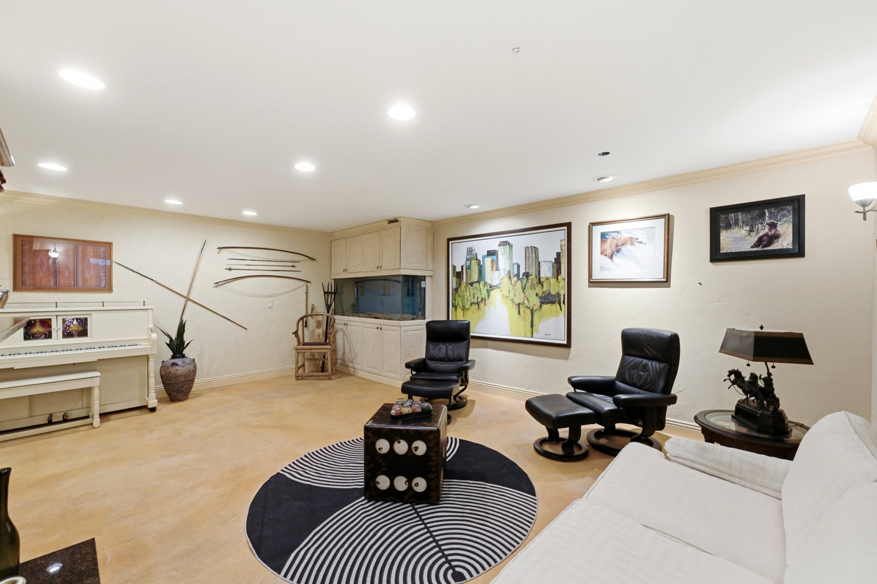 Spacious living area featuring recessed lighting, crown molding, and light-colored flooring
