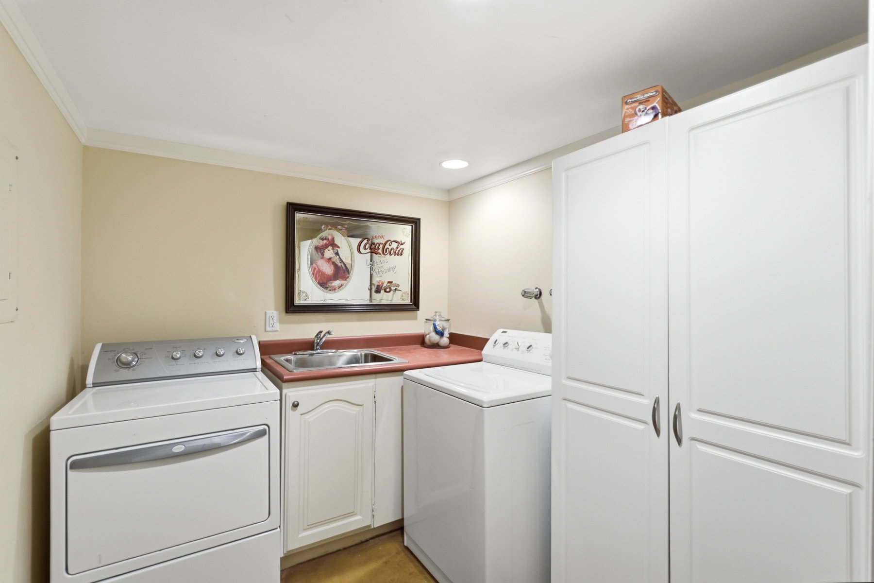 Utility area featuring built-in cabinetry, a basin sink, and a countertop