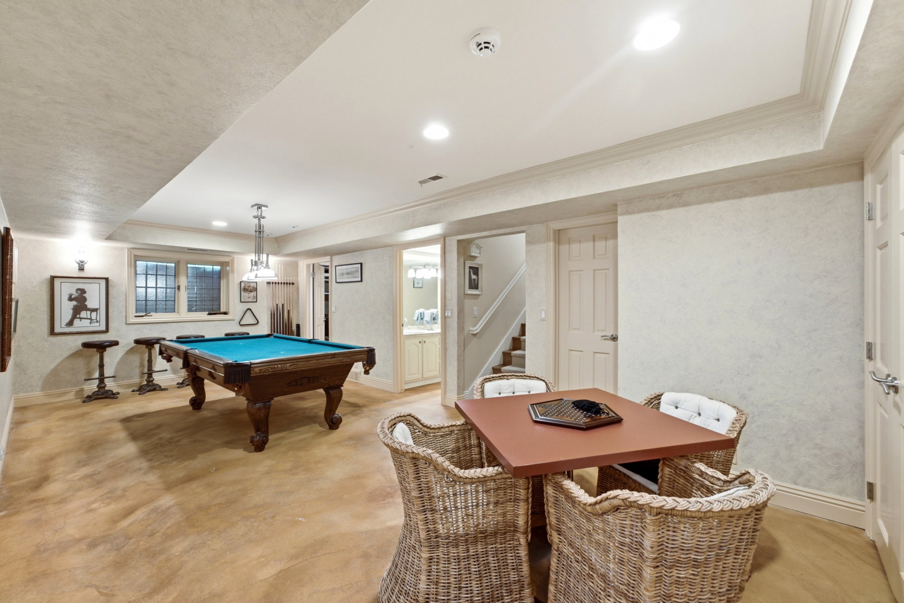 Lower level entertainment space featuring durable flooring and recessed lighting