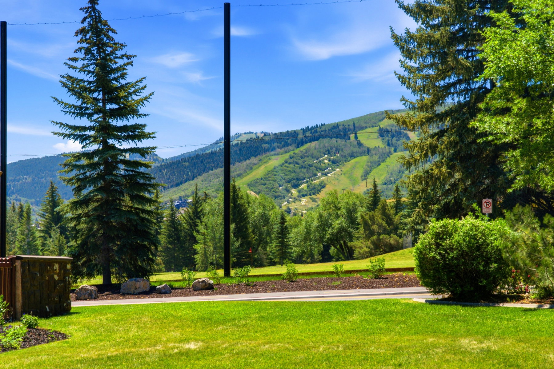 Expansive mountain terrain with visible ski runs provides a prominent natural backdrop