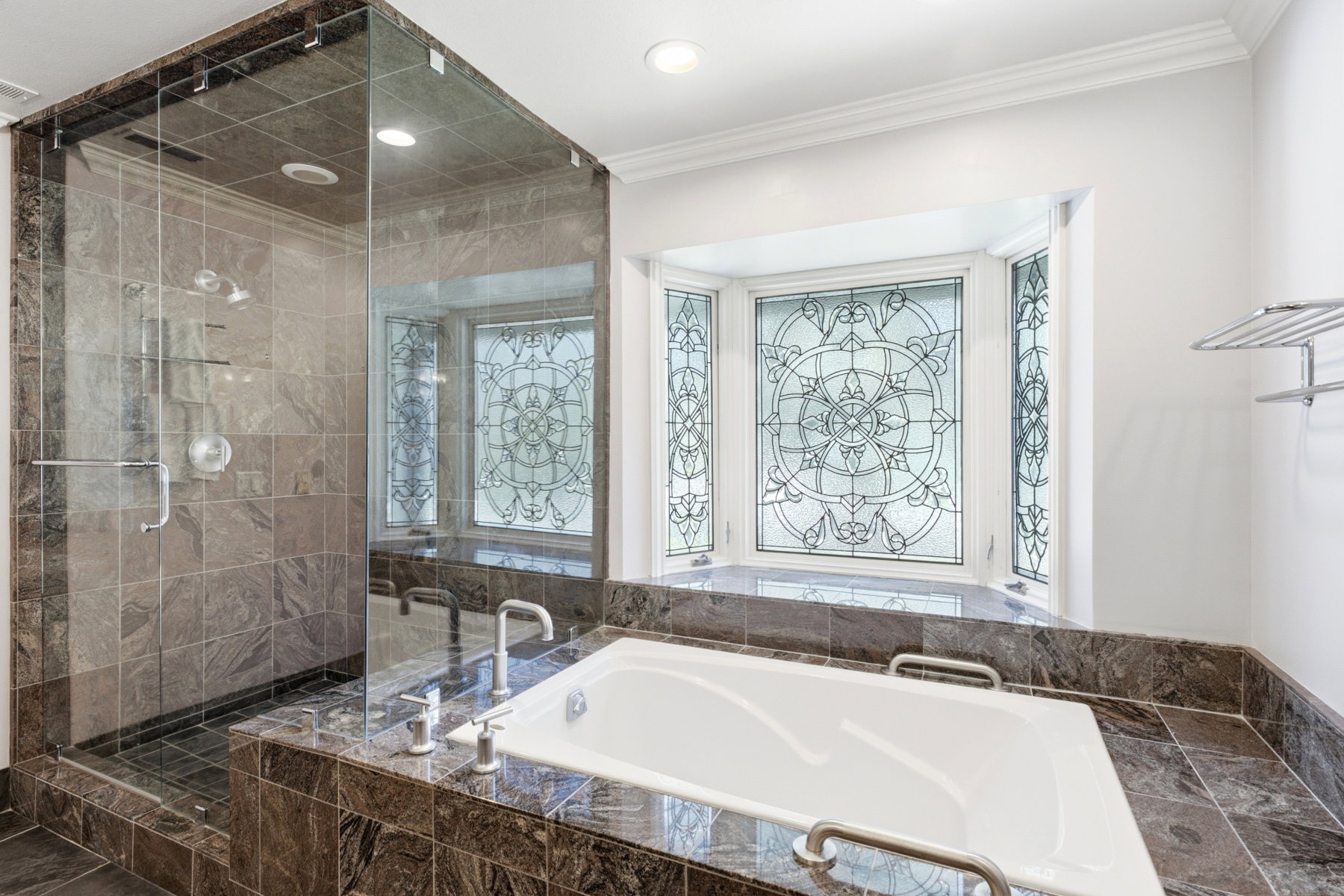 Spa-like bathroom with a spacious walk-in shower featuring glass enclosure and tiled walls