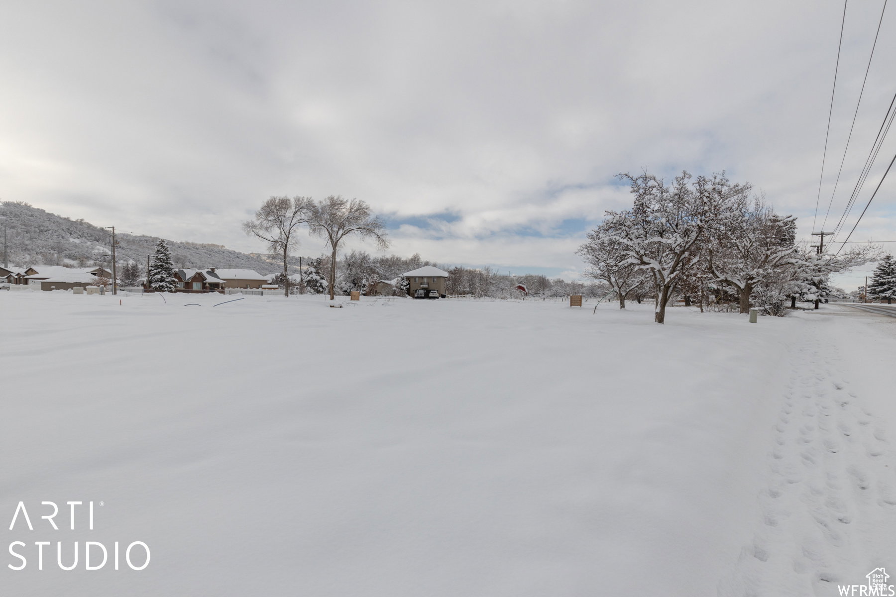 Expansive snow-covered lot featuring a level terrain