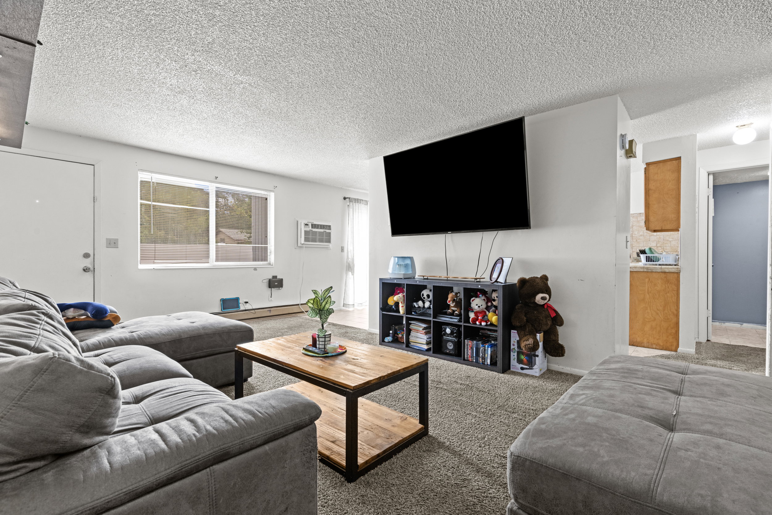Open concept living area with carpeted flooring