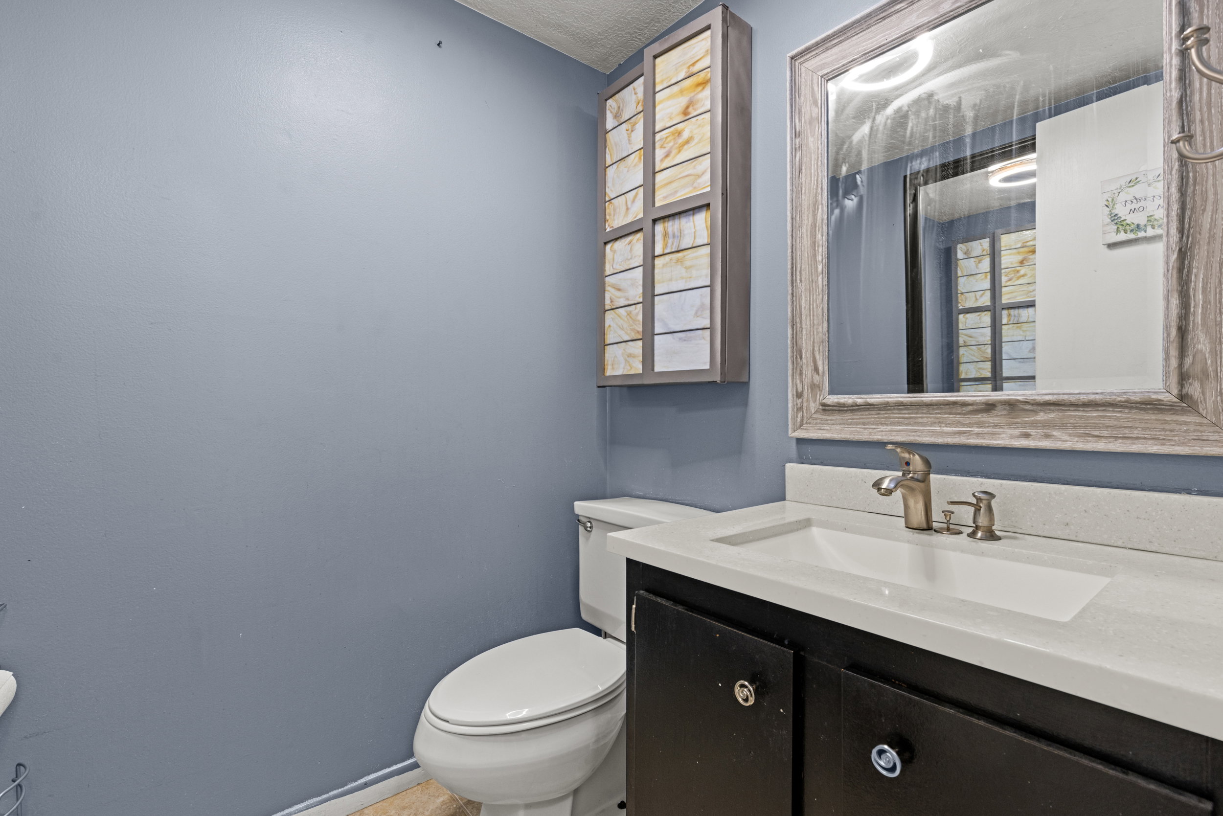 Vanity with an integrated sink and light-toned countertop