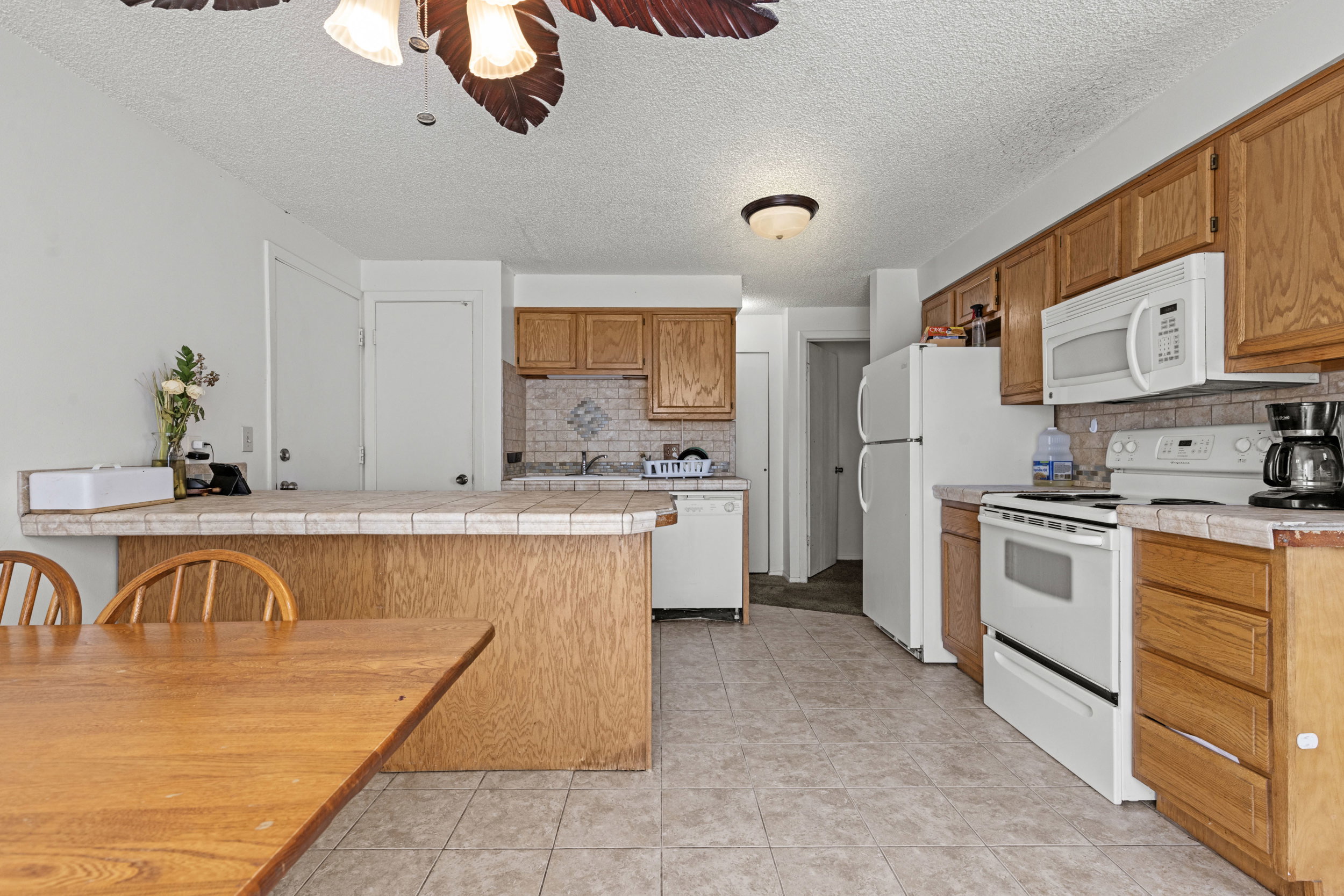 Kitchen featuring wood-finish cabinetry and a tiled backsplash