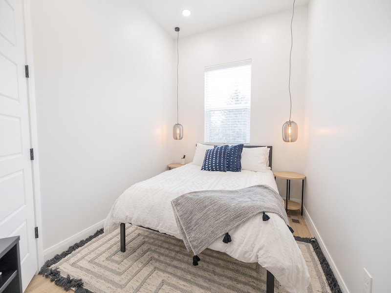 Bedroom featuring high ceilings, recessed lighting, and wood-finish flooring