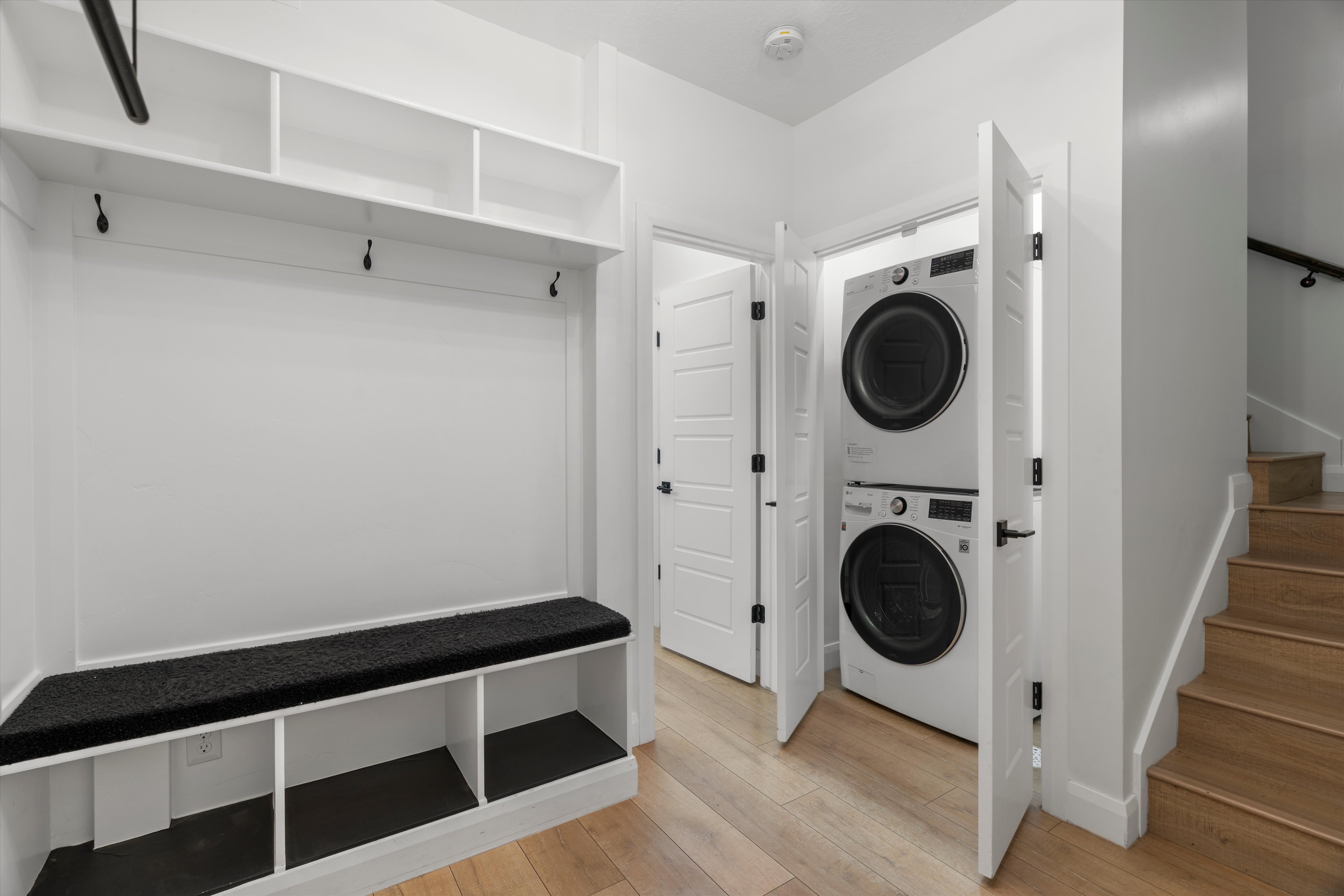 Built-in mudroom bench with cubby storage and upper shelving