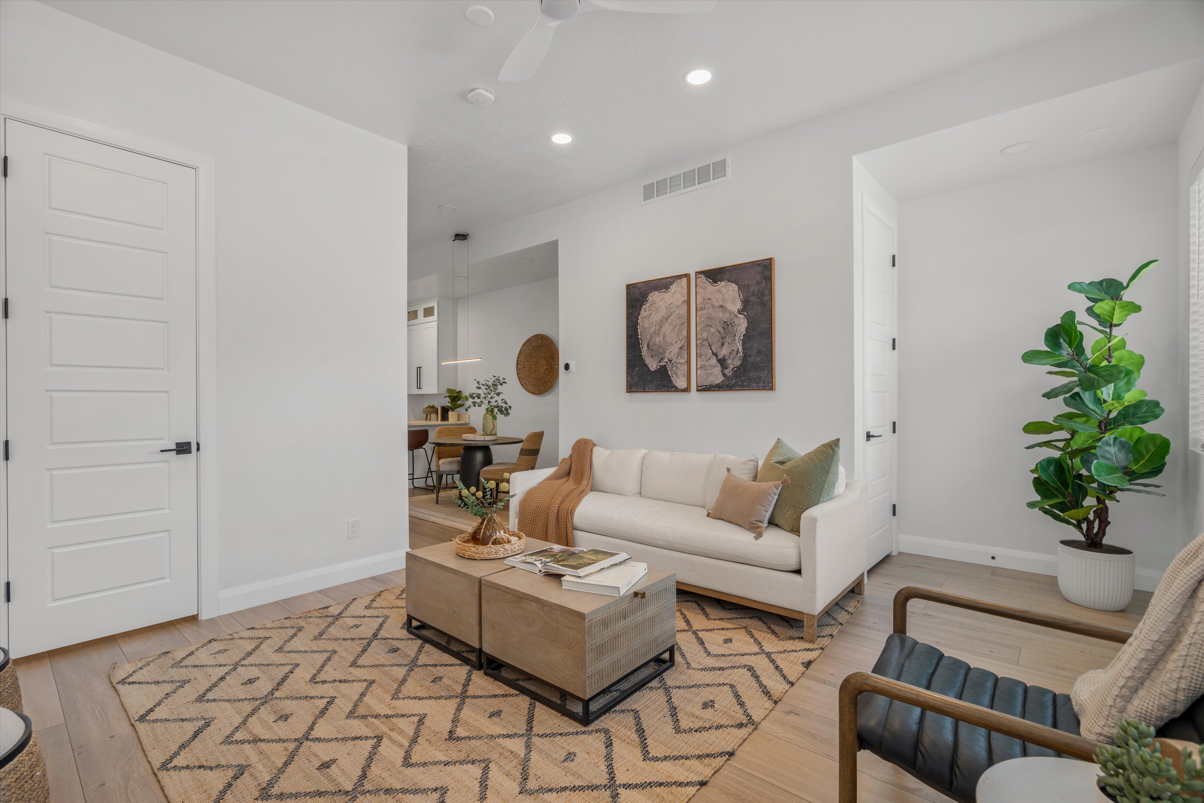 Light-filled living area featuring wood-finish flooring, recessed lighting, and a neutral color palette