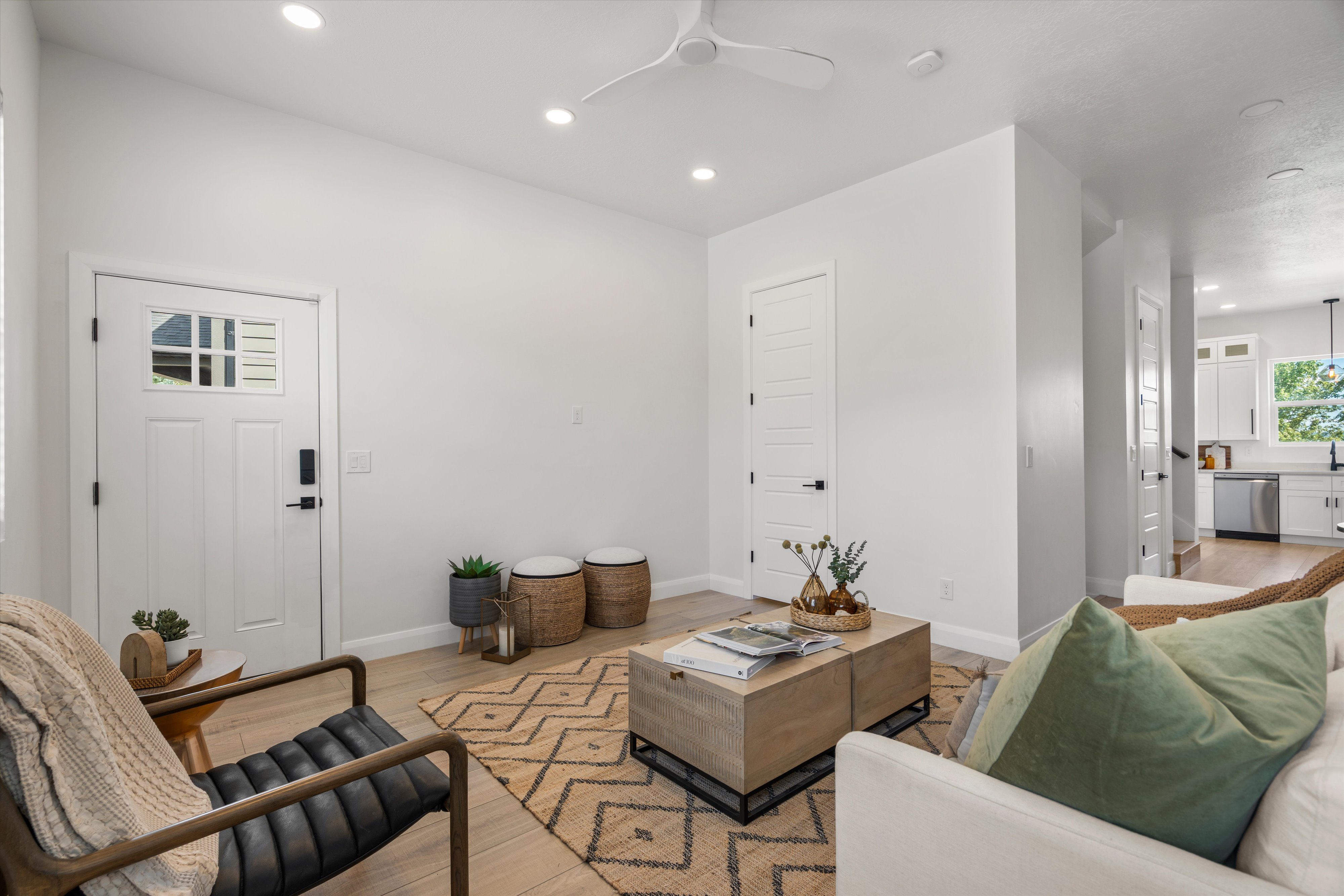 Bright open-concept living space with recessed lighting and a ceiling fan