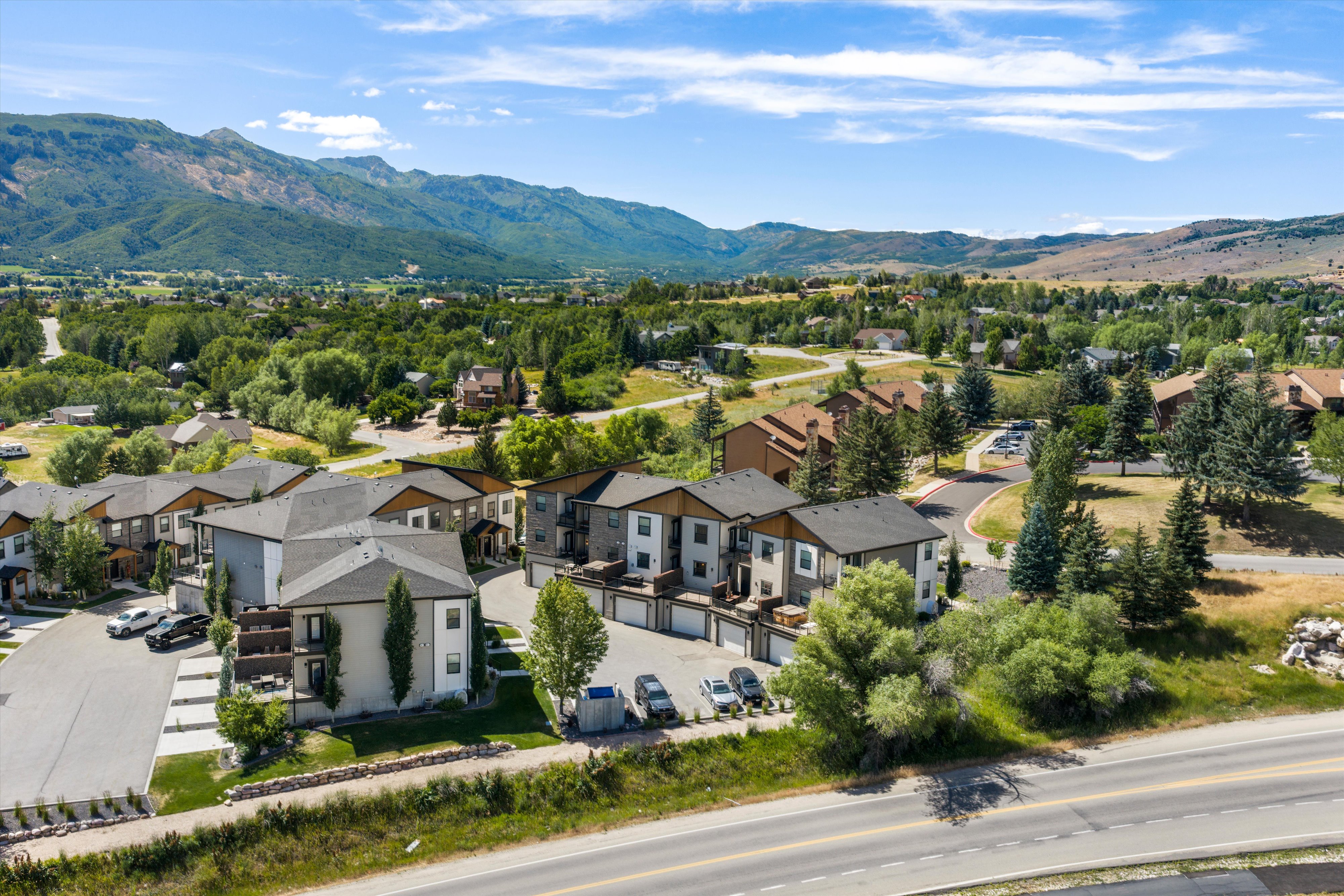 Contemporary multi-story buildings featuring neutral-toned siding and dark-pitched roofs