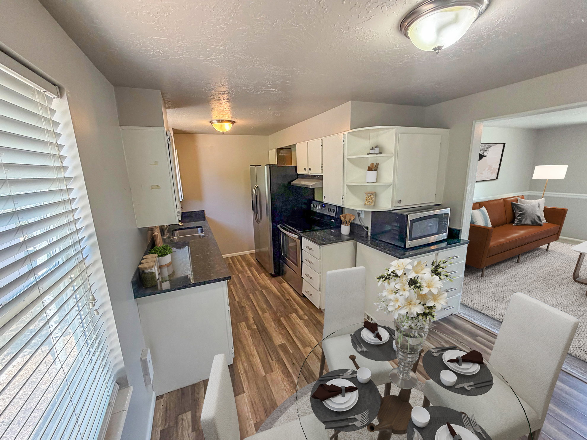 Kitchen featuring white cabinetry, dark stone countertops, stainless steel appliances, wood-finish flooring, and recessed lighting