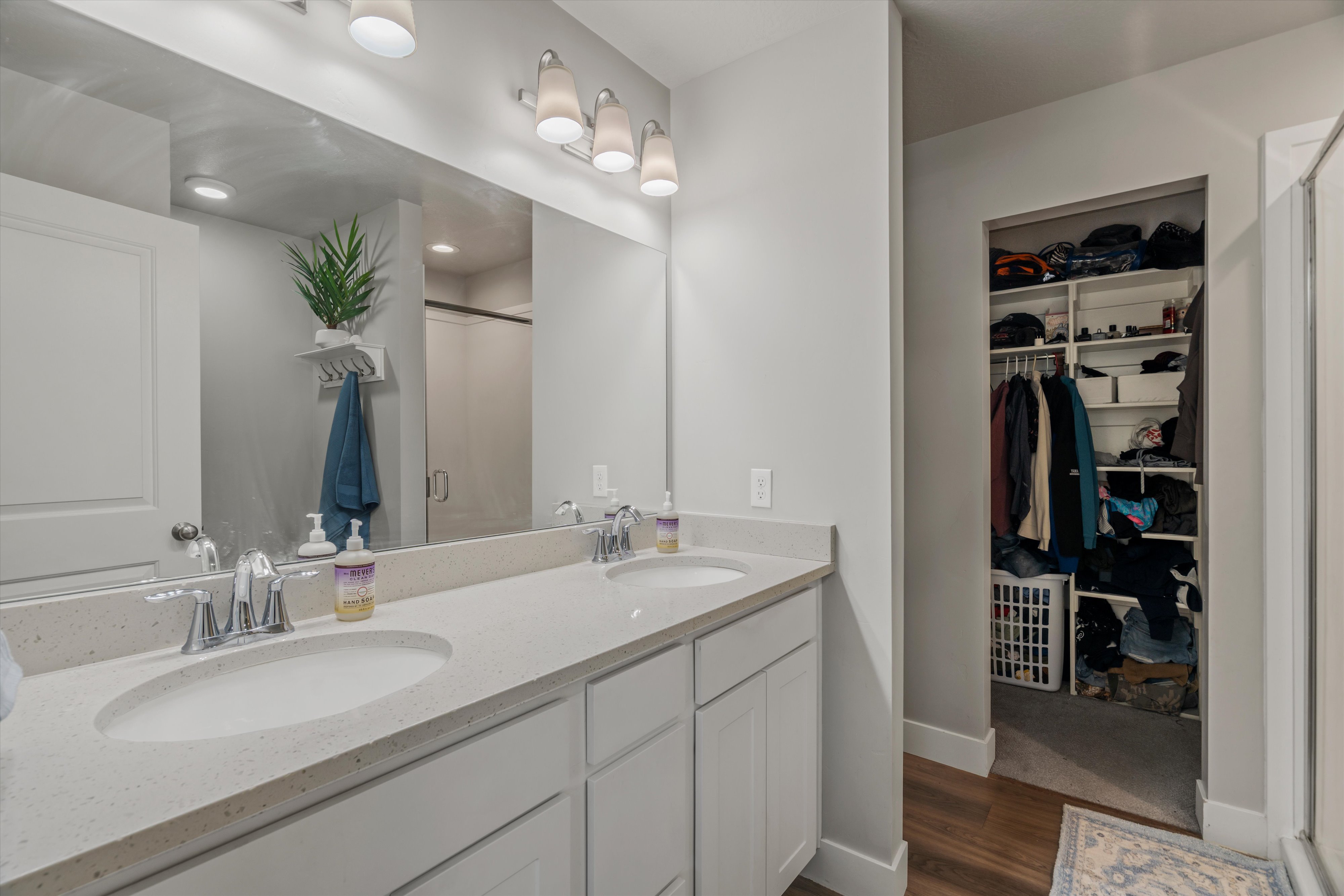 Double vanity featuring integrated sinks, light-toned countertops, and chrome fixtures