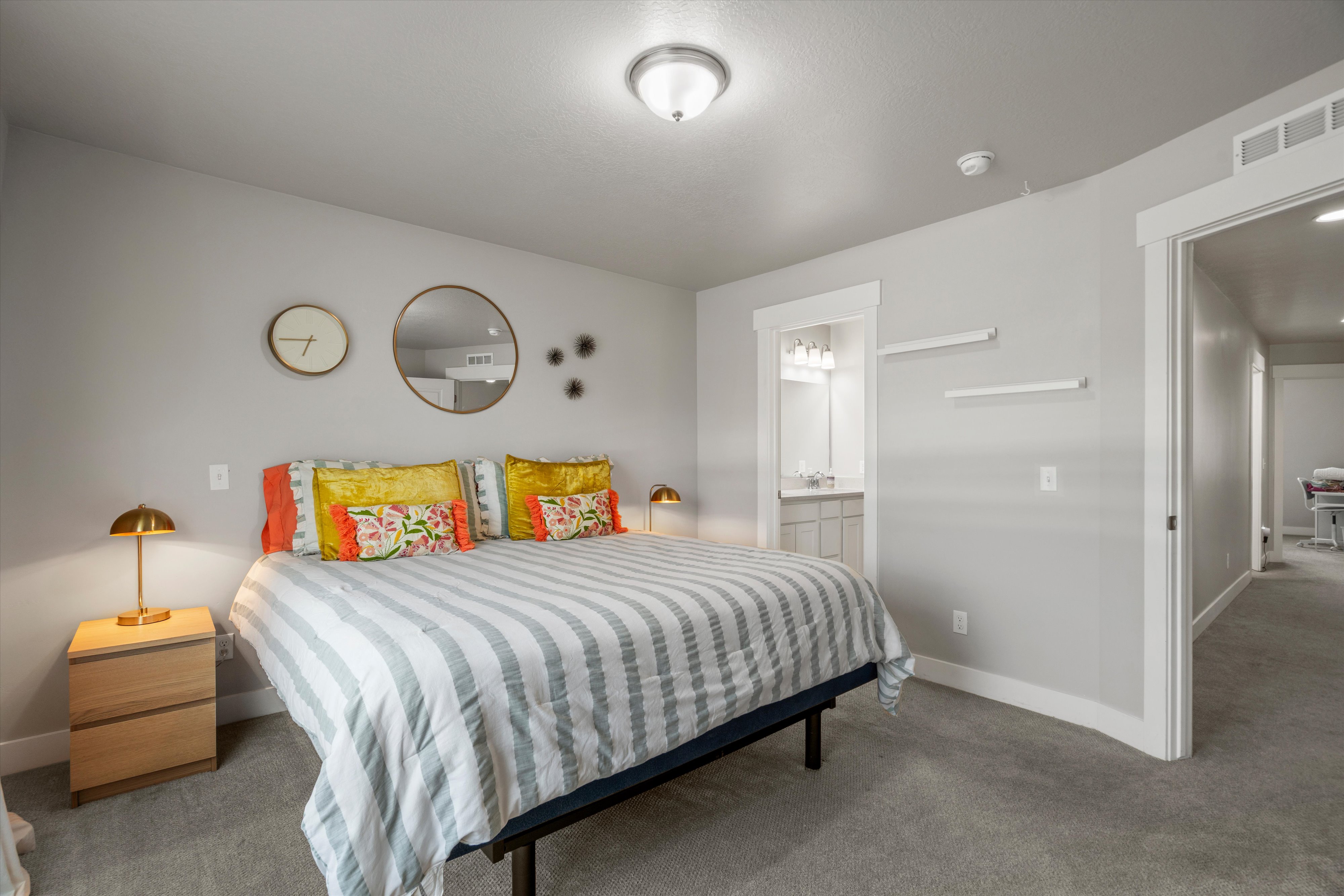 Bedroom featuring light grey walls, white trim, and grey carpeting
