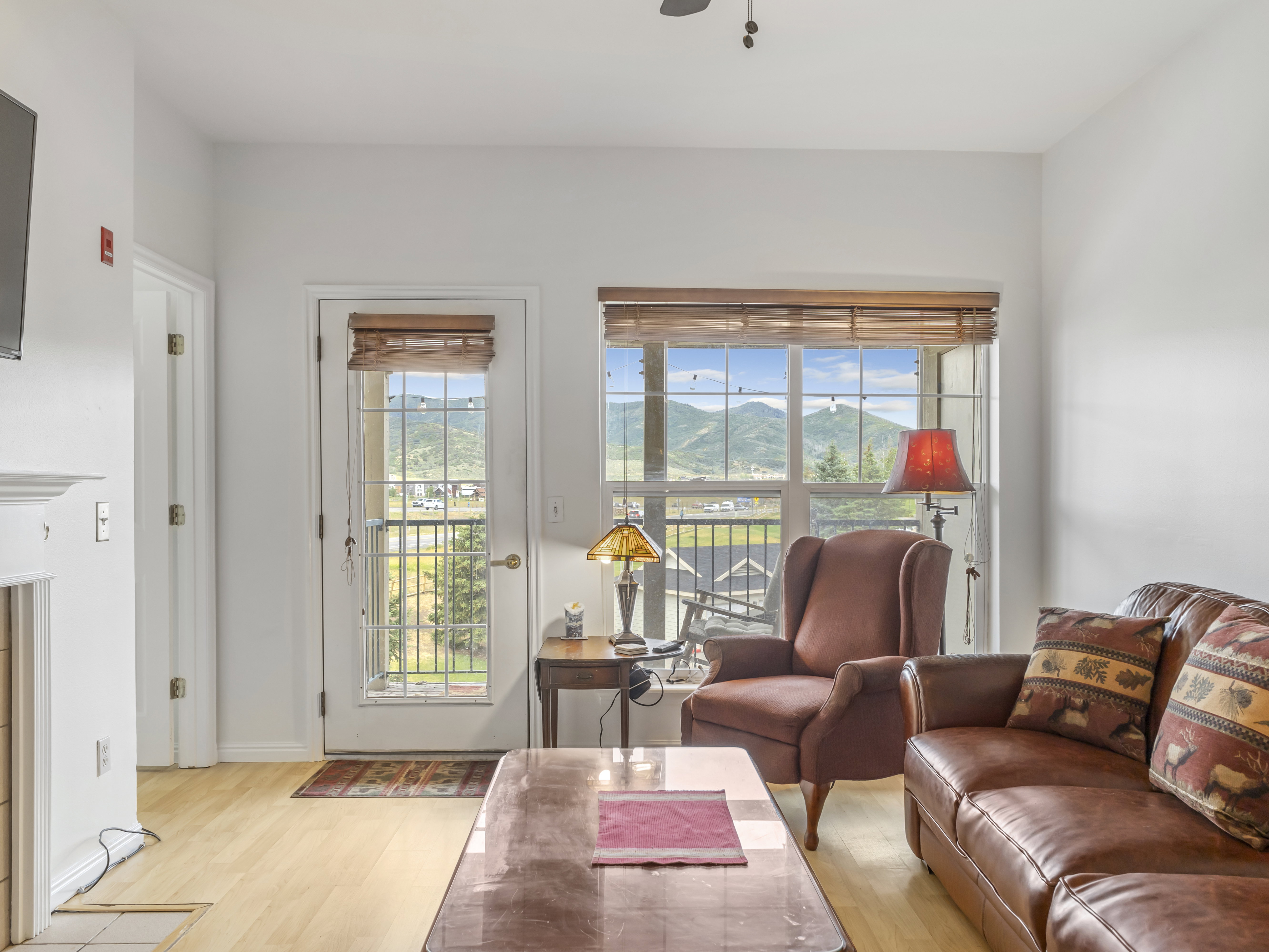 Bright living space featuring light wood-finish flooring and white walls