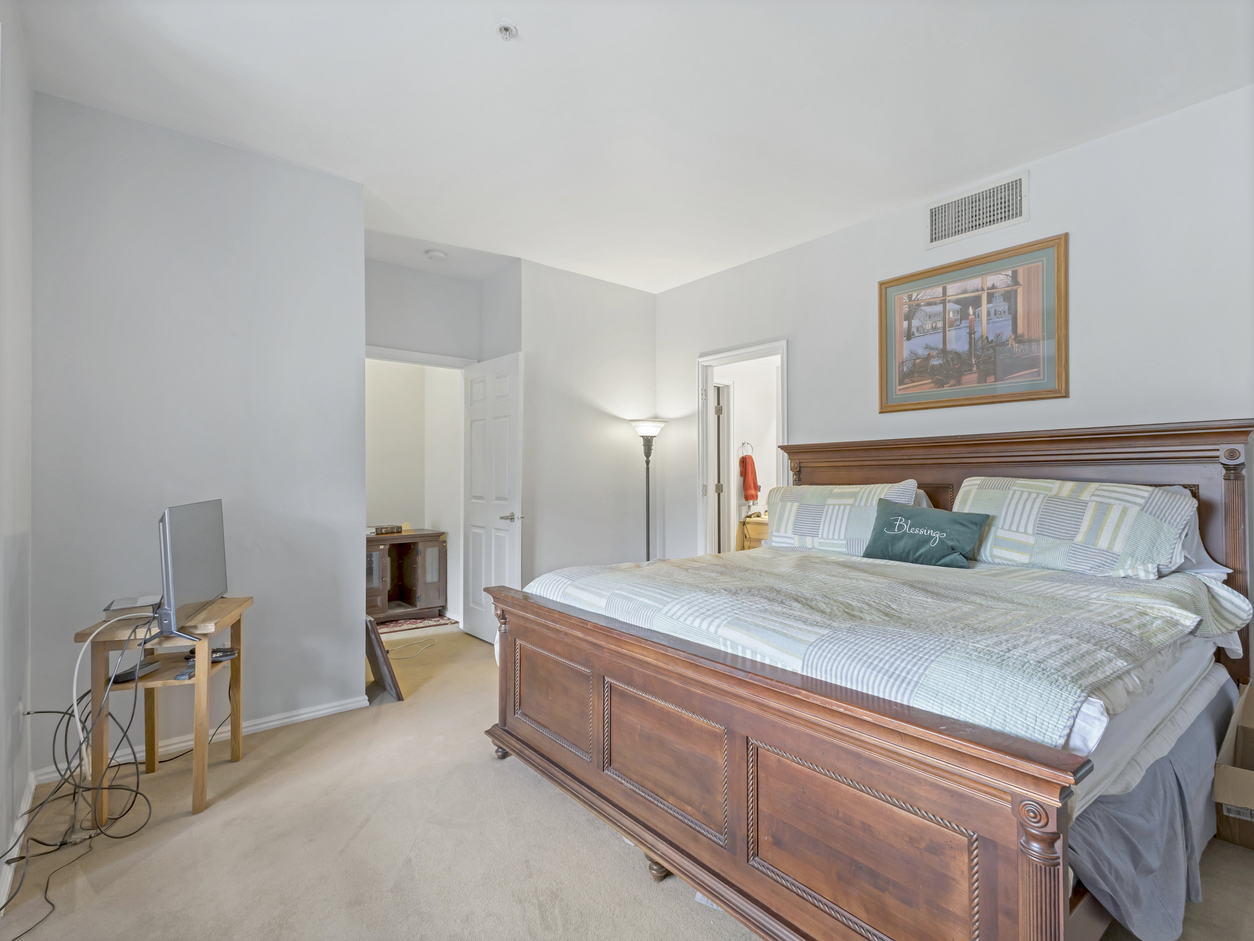 Spacious room featuring neutral carpeting and light gray wall tones